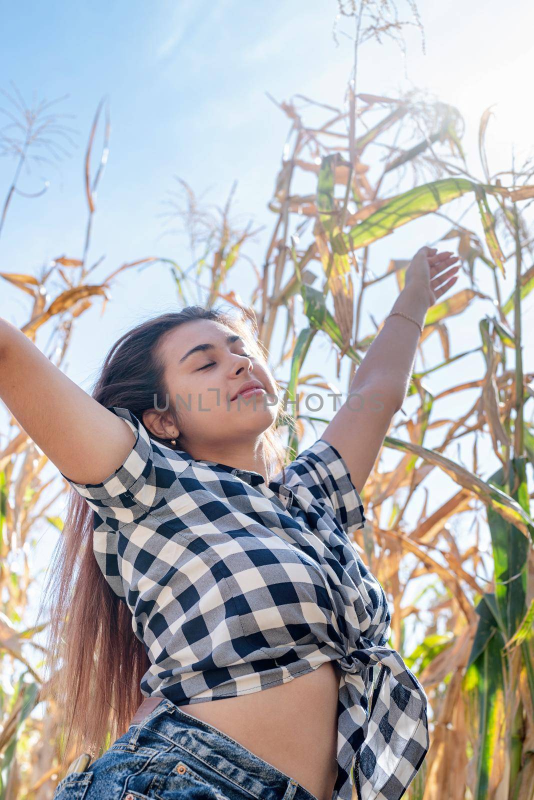 agriculture and cultivation concept. Countryside. Cheerful female caucasian woman in the corn crop