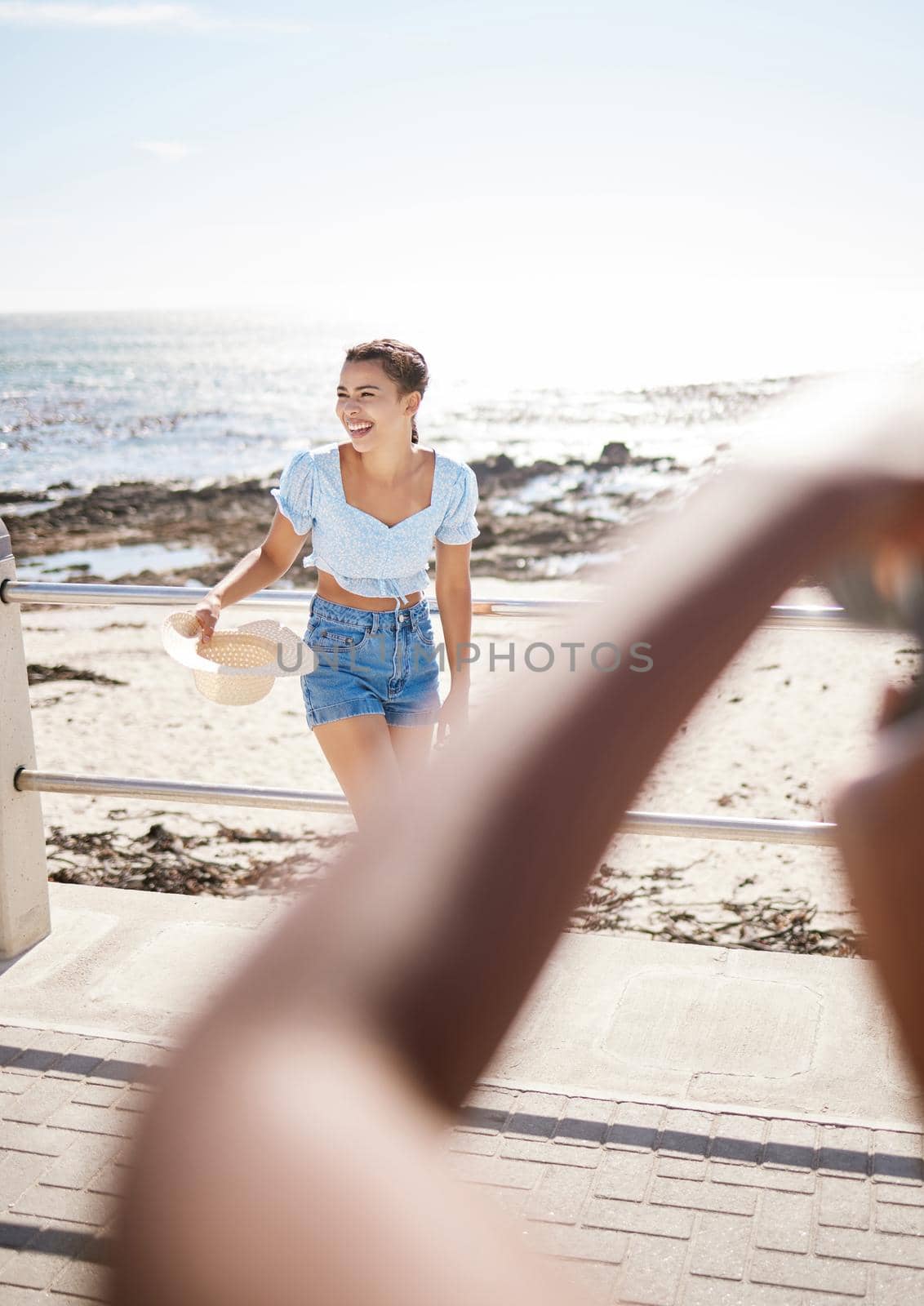 Beach travel photography of social media woman influencer on summer holiday or seaside water vacation destination. Happy, smile or excited young girl enjoy ocean, sand and blue sky sunset Hawaii trip.
