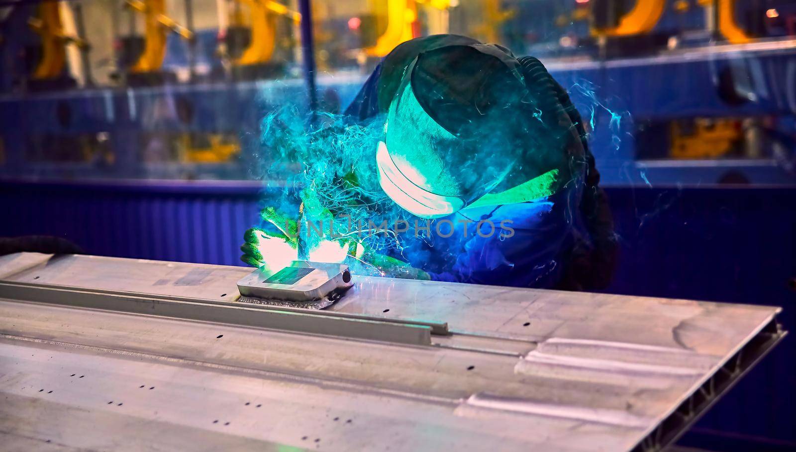 Workshop for assembling metal frames for subway cars, trams and trains. Welders assemble body parts.