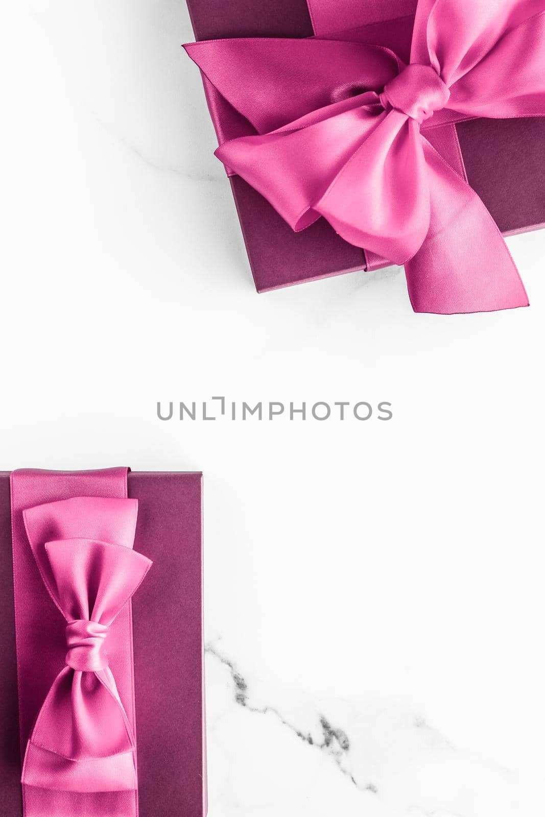 Birthday, wedding and girly branding concept - Pink gift box with silk bow on marble background, girl baby shower present and glamour fashion gift for luxury beauty brand, holiday flatlay art design