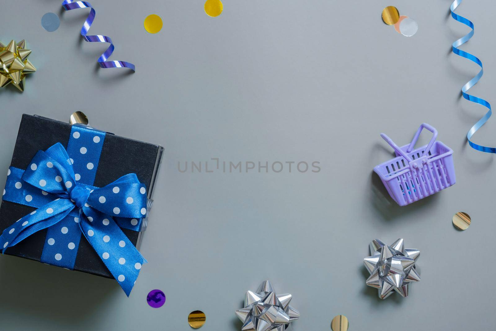 Gift, shopping basket and festive tinsel flat lay with copy space. Top view