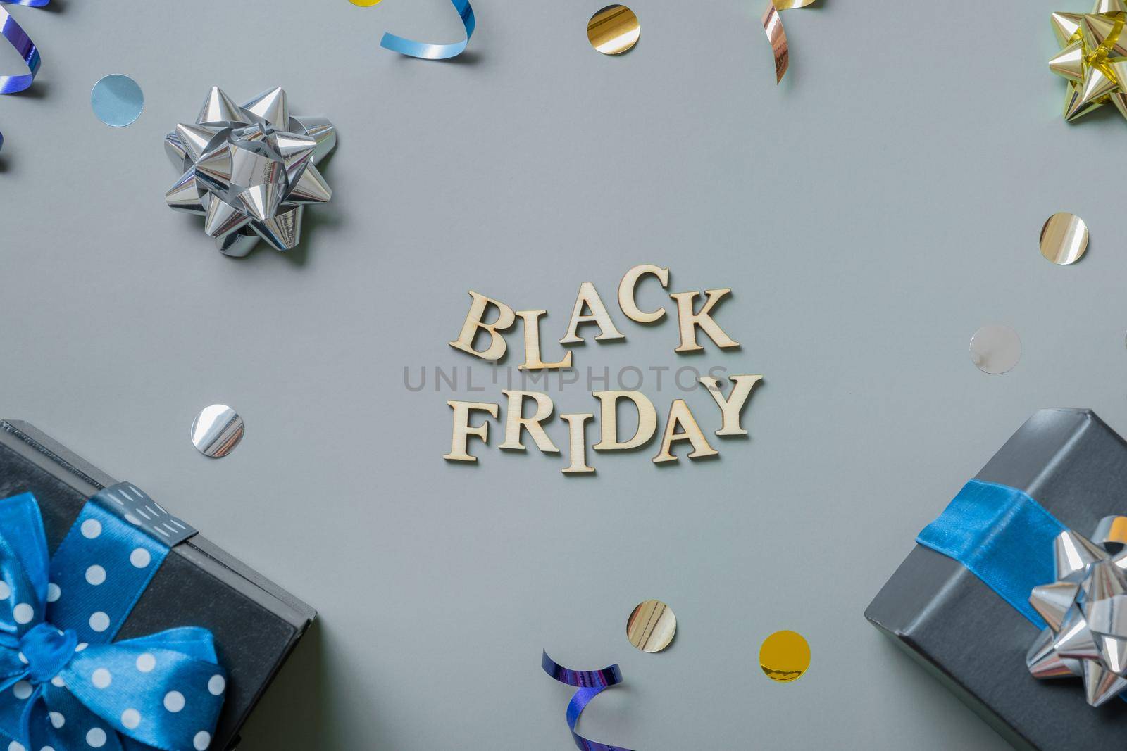 Black friday text with gifts and festive tinsel flat lay by ssvimaliss