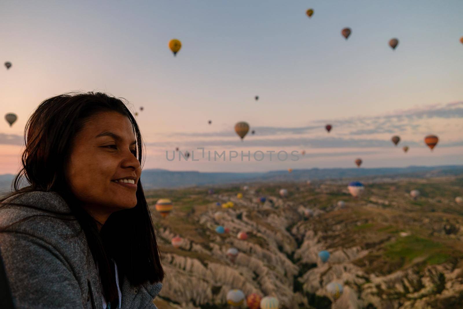 Asian women in hot air balloon during sunrise in Cappadocia Turkey, Kapadokya Goreme by fokkebok