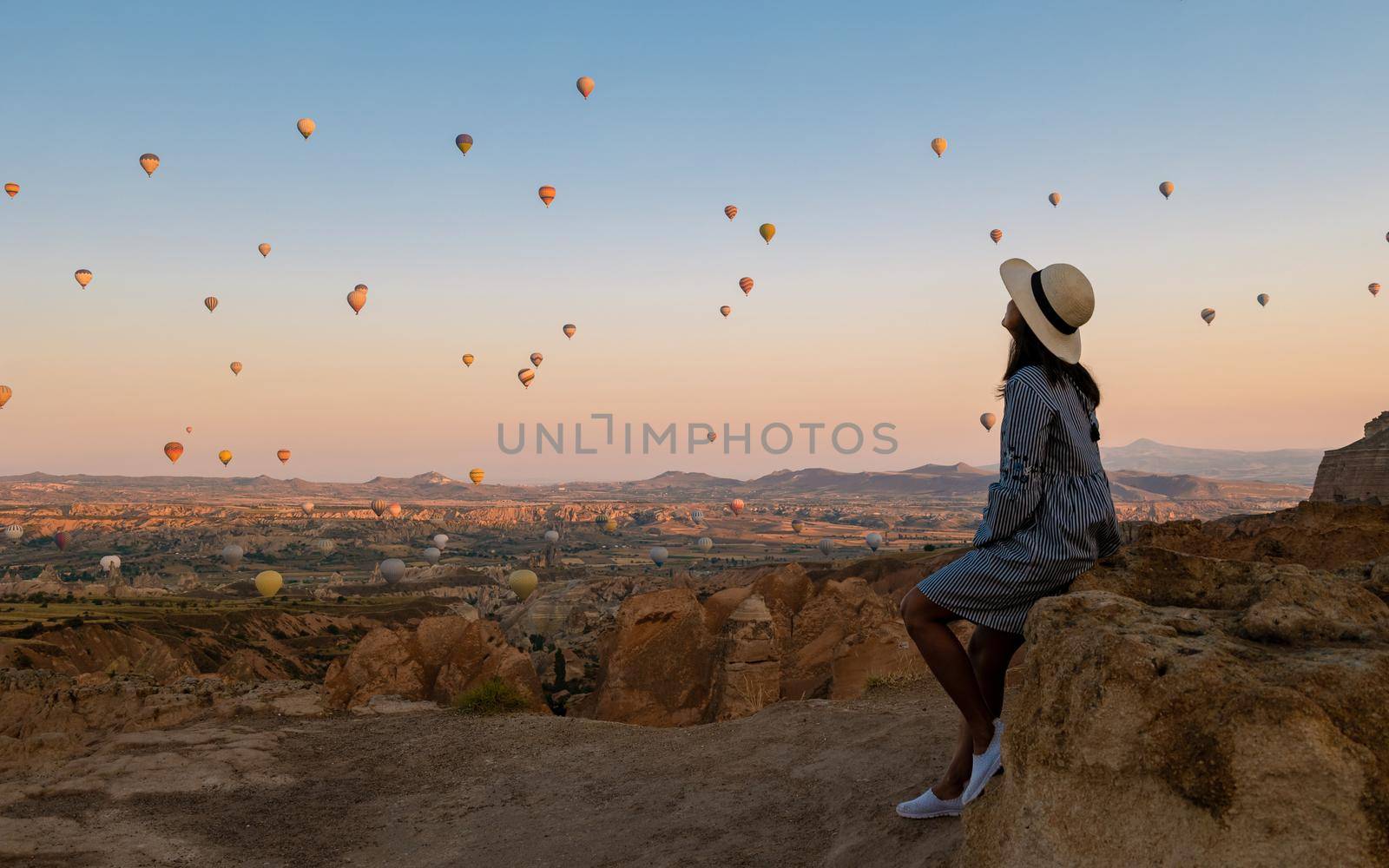 Asian women in hot air balloon during sunrise in Cappadocia Turkey, Kapadokya Goreme by fokkebok