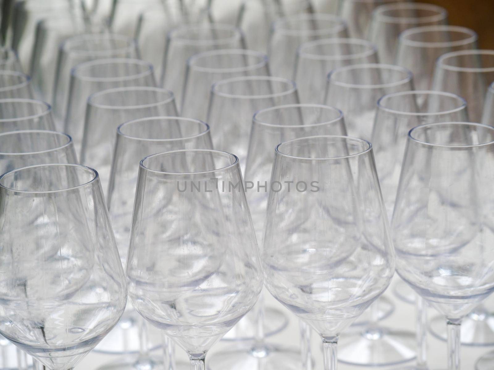 a group of wine glasses in event preparation - catering concept by verbano