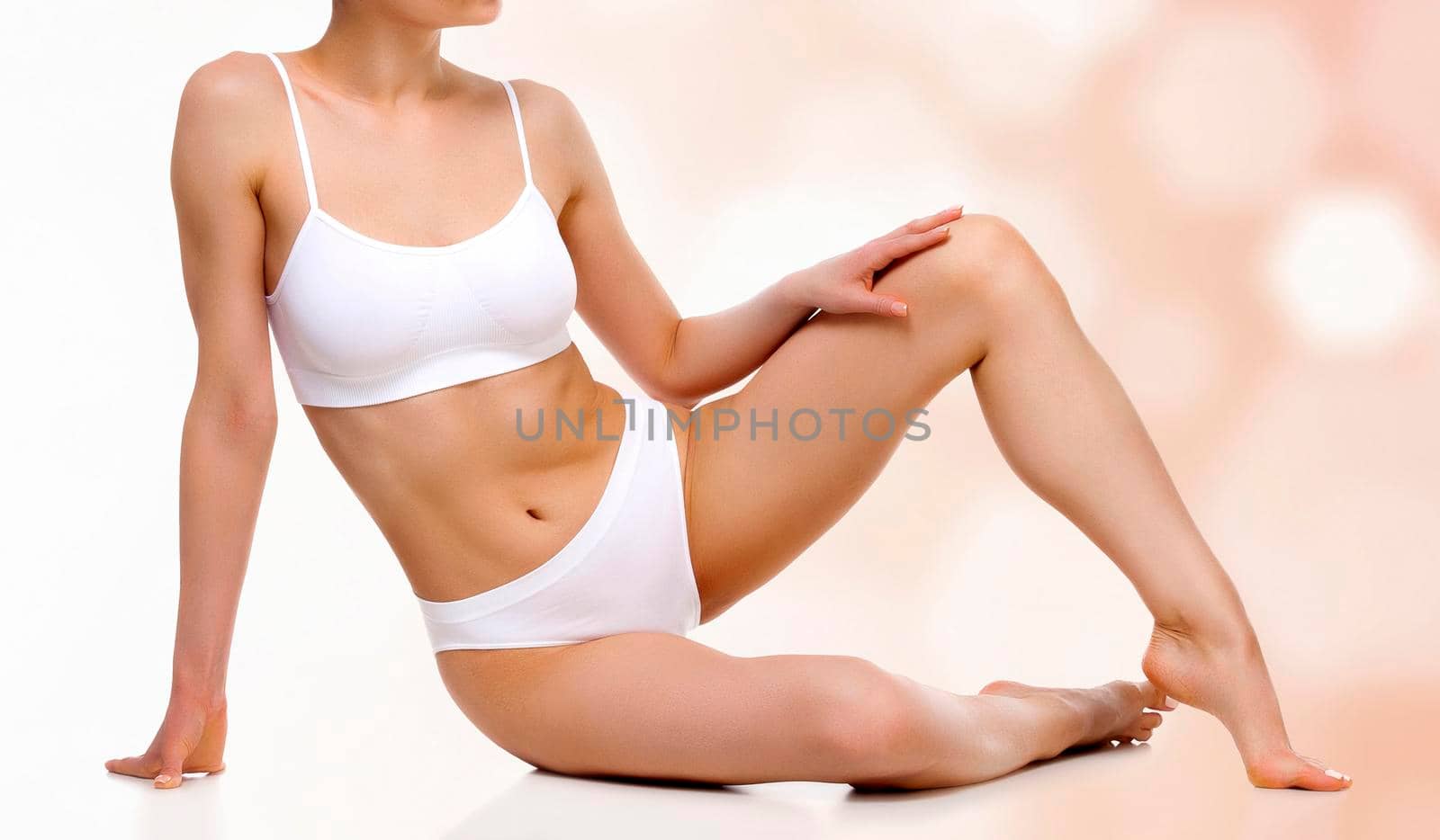 Young woman with slim body and smooth clean skin against an abstract background with circles and copyspace