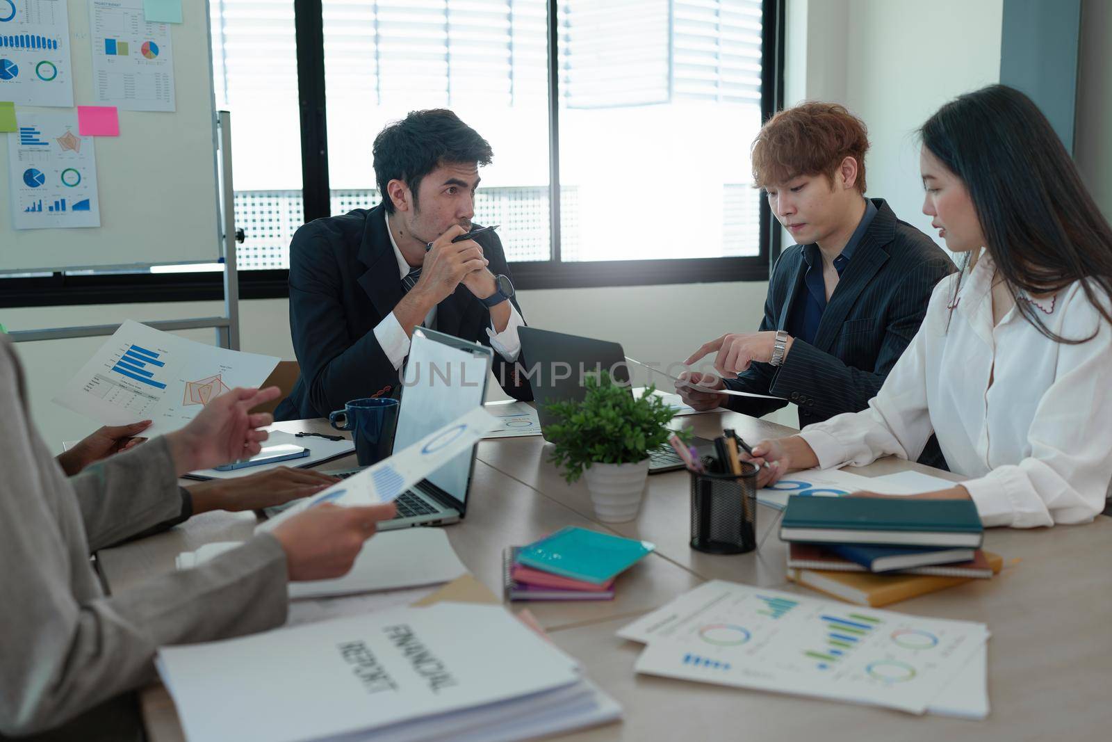 Analytics intelligence concept. Group of business people discuss current financial and economic on laptop for investment at the meeting by itchaznong