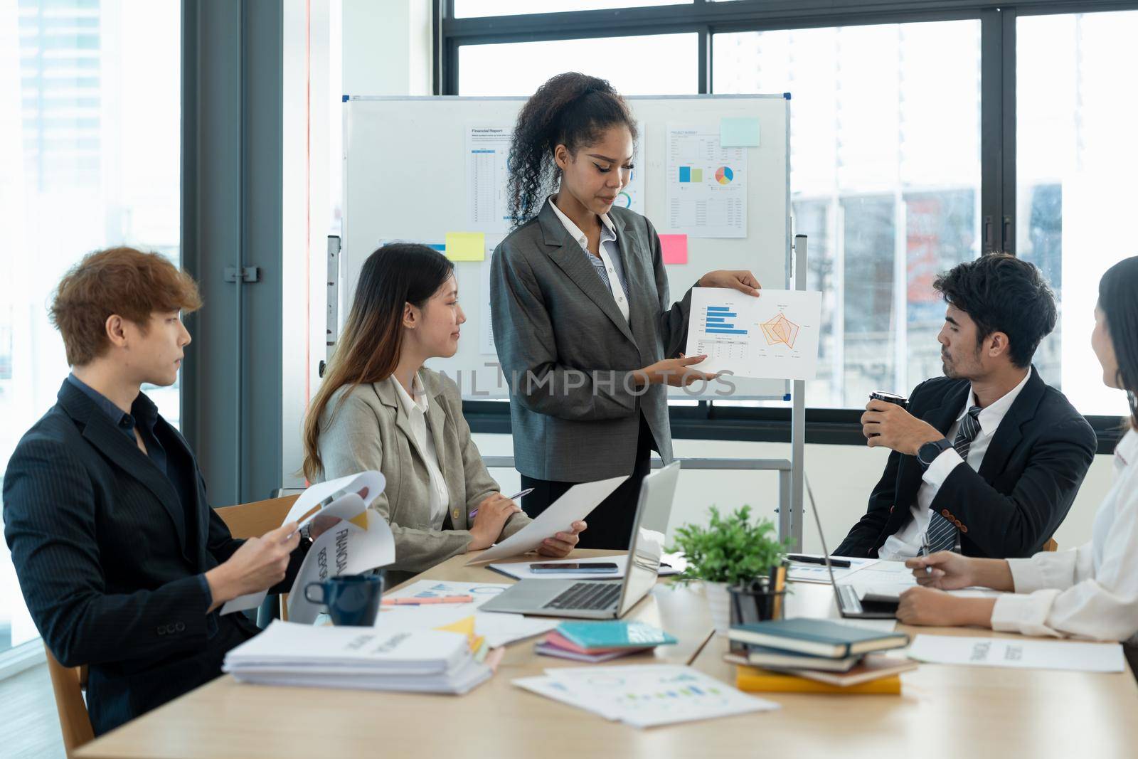 diverse business team people discuss financial result review paperwork share ideas brainstorm collaborate work in teamwork at group briefing table