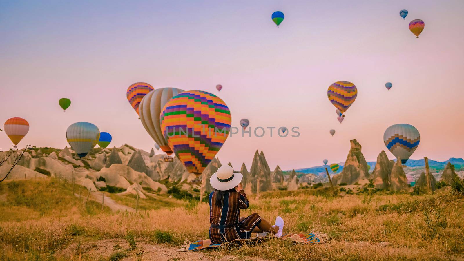 Asian women in hot air balloon during sunrise in Cappadocia Turkey, Kapadokya Goreme by fokkebok