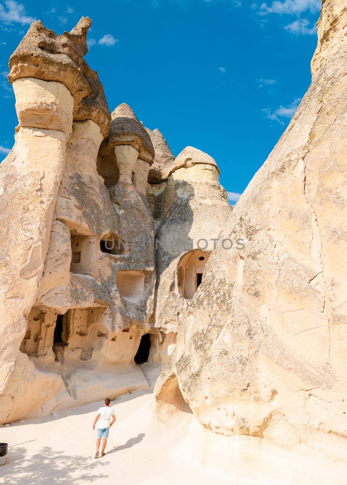 Pasabag Monks Valley happy young menon vacation in Turkey Cappadocia, Rock Formations in Pasabag Monks Valley, Cappadocia, Turkey.