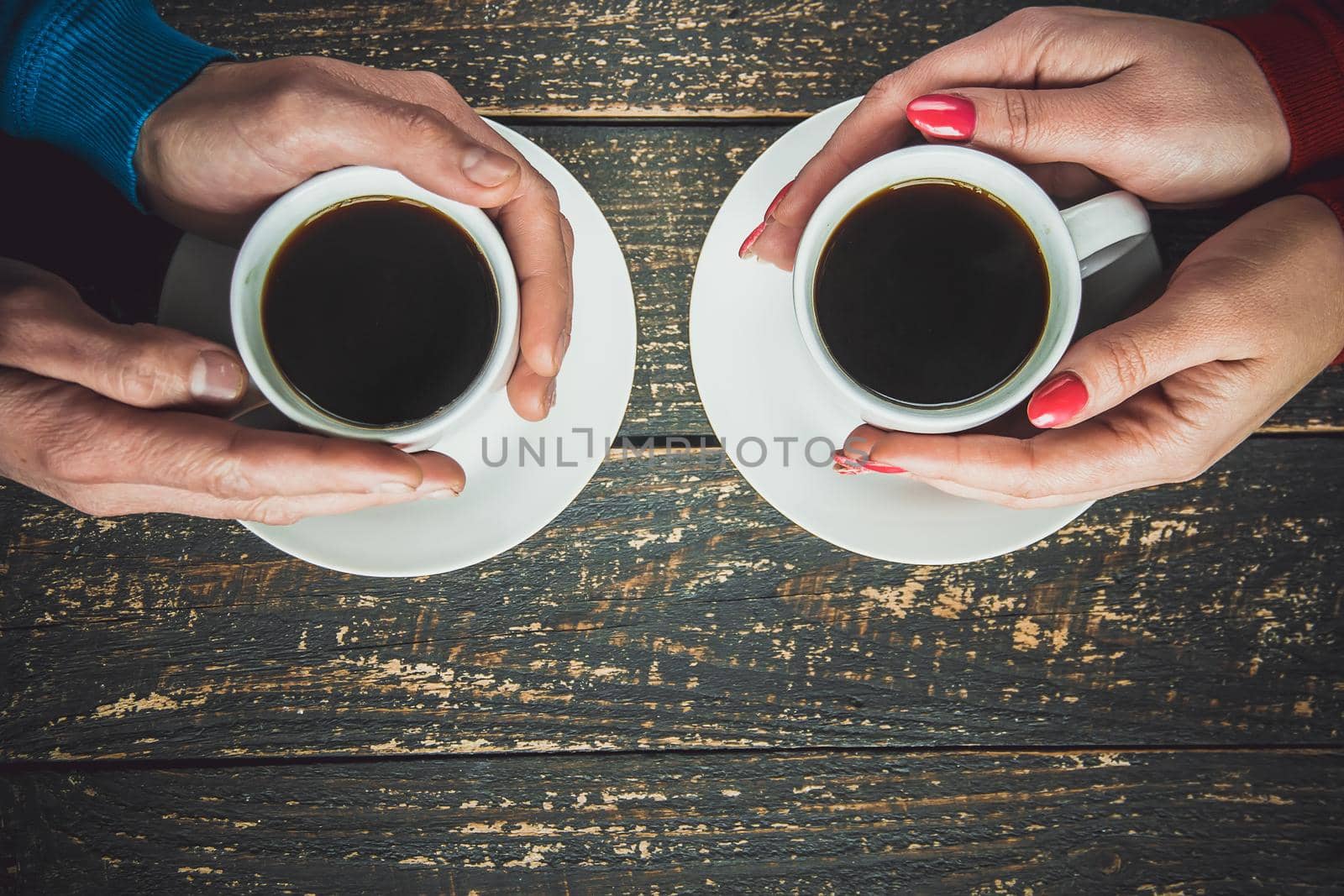 Cup drink for Breakfast in the hands of lovers. Selective focus. by yanadjana