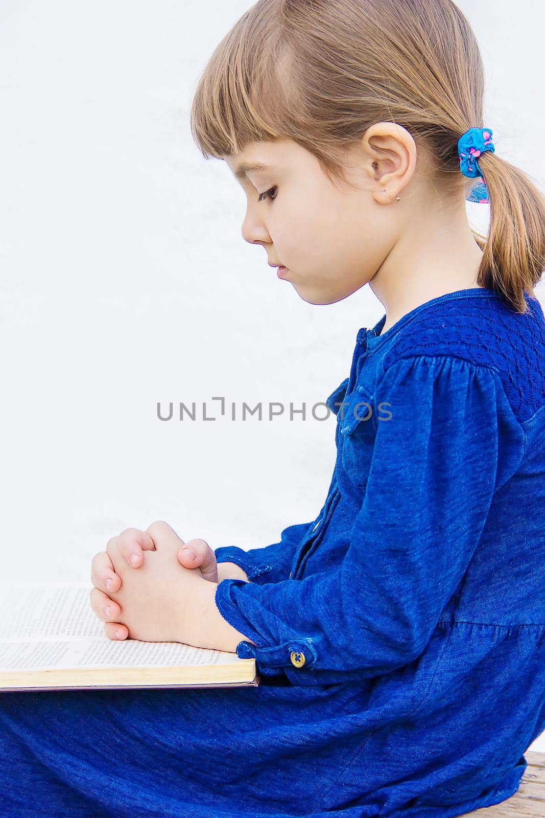 The child prays to God. Selective focus.