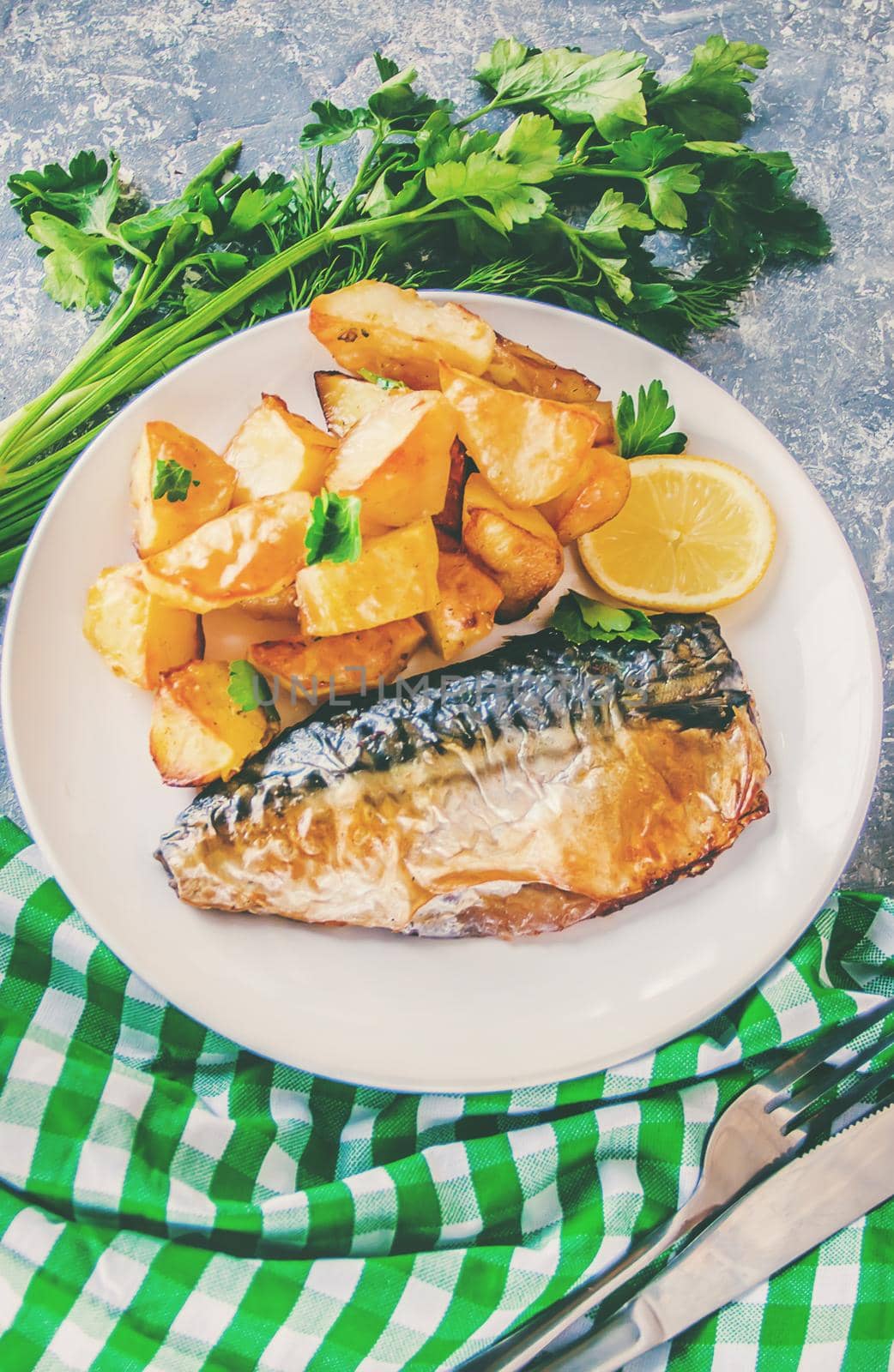 baked fish mackerel and potatoes. Selective focus. food