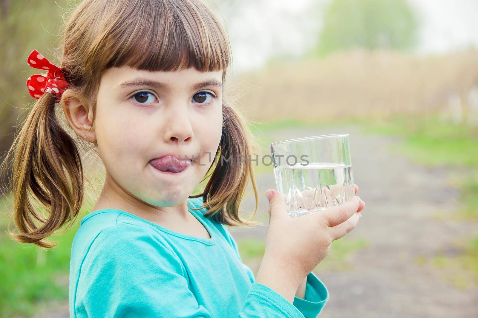 child glass of water. selective focus. Kids. by yanadjana