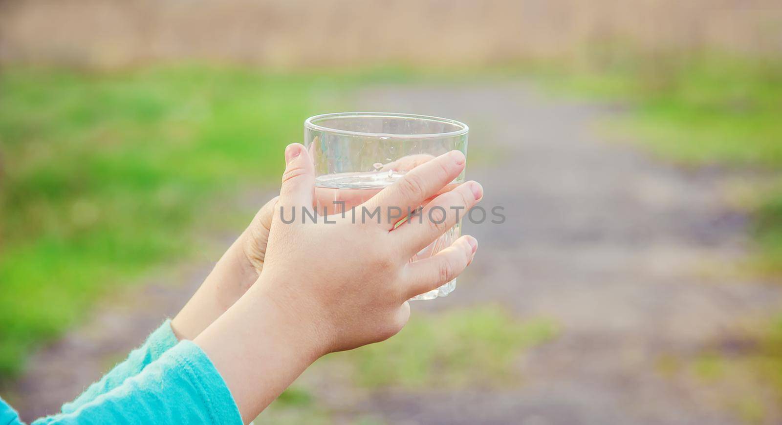 child glass of water. selective focus. Kids.