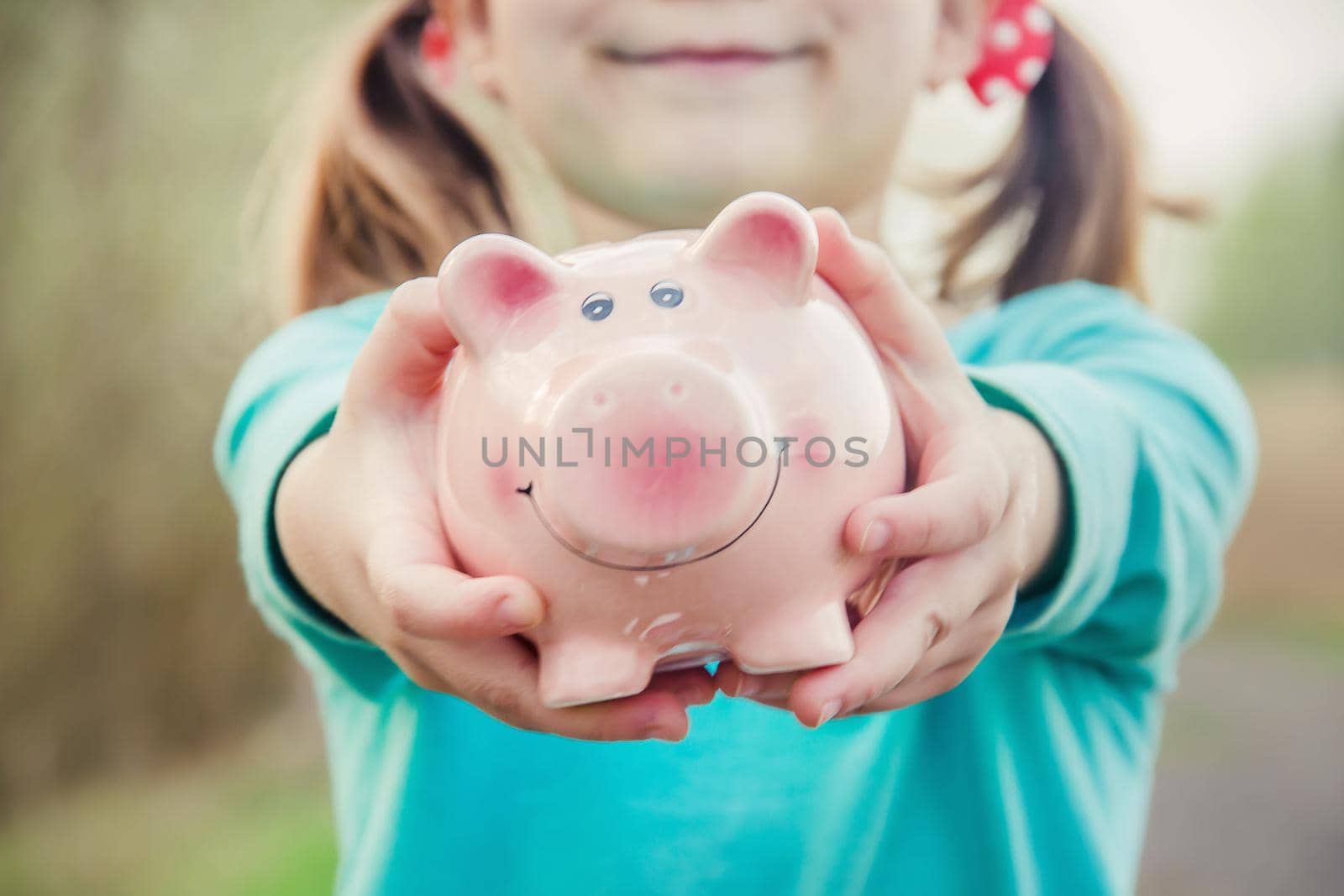 piggy bank in the hands of a child. saving. selective focus.