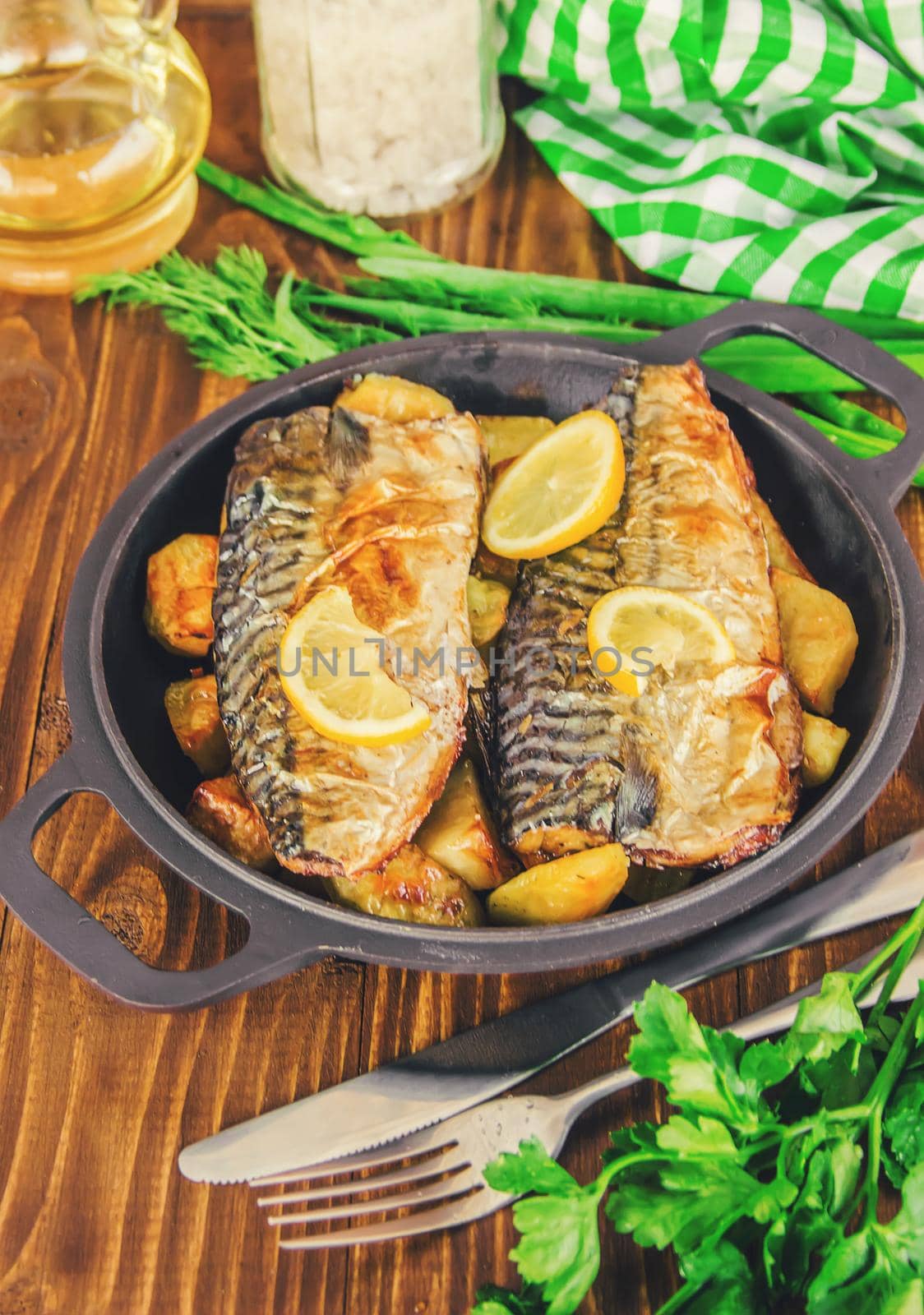 baked fish mackerel and potatoes. Selective focus. by yanadjana