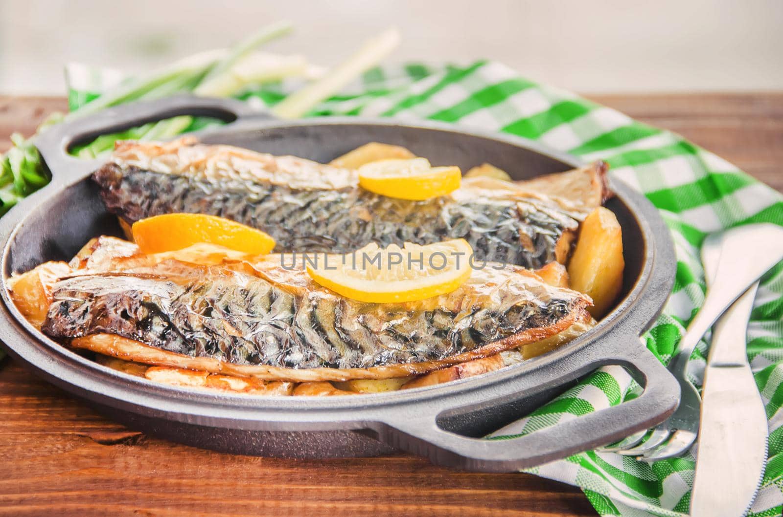 baked fish mackerel and potatoes. Selective focus. by yanadjana