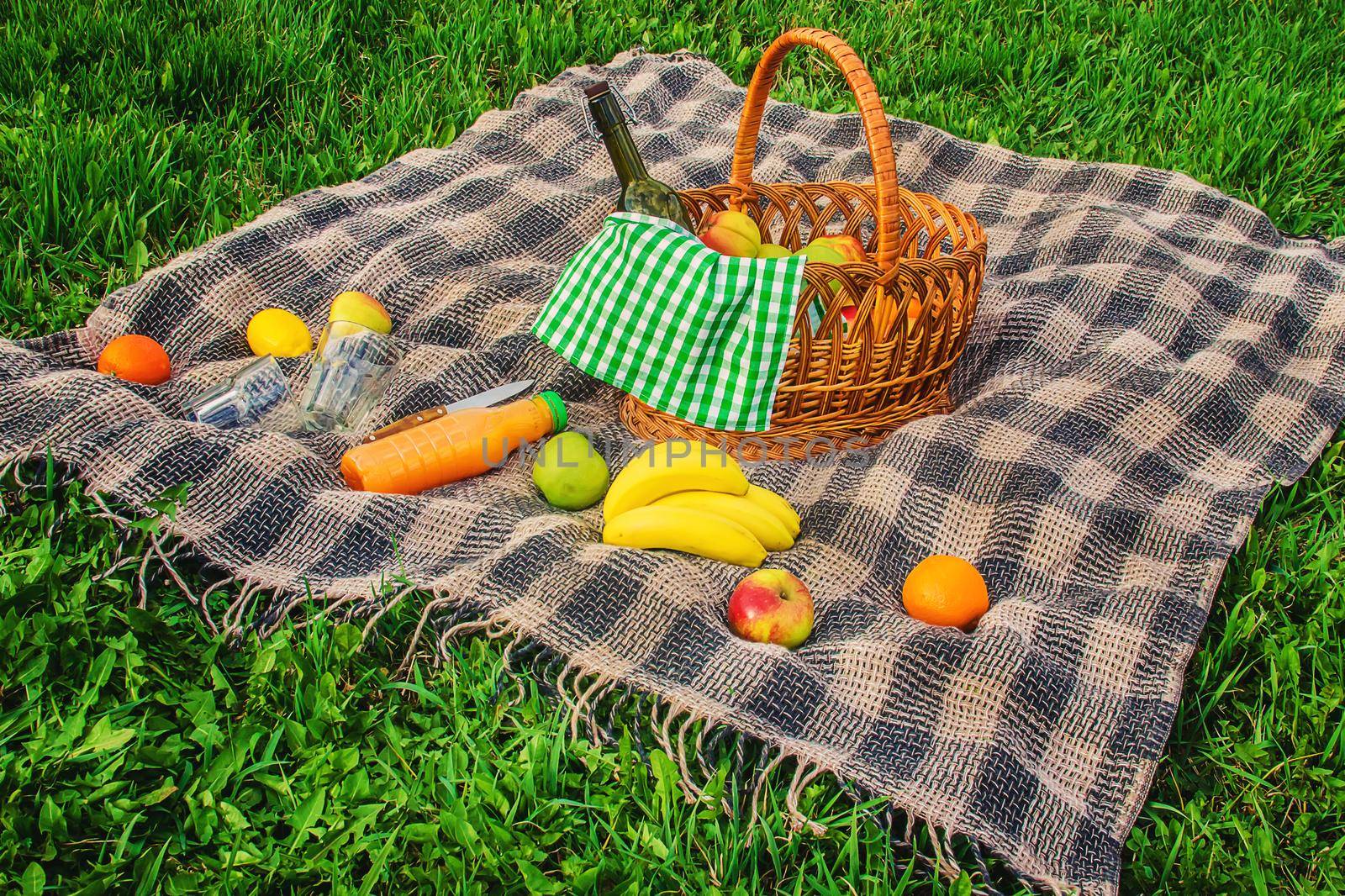 Plaid for a picnic on the grass. Selective focus.