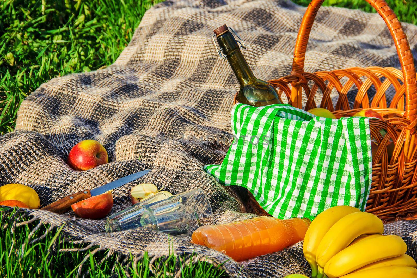 Plaid for a picnic on the grass. Selective focus. by yanadjana