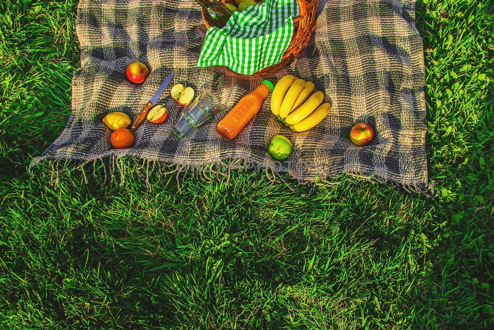 Plaid for a picnic on the grass. Selective focus.