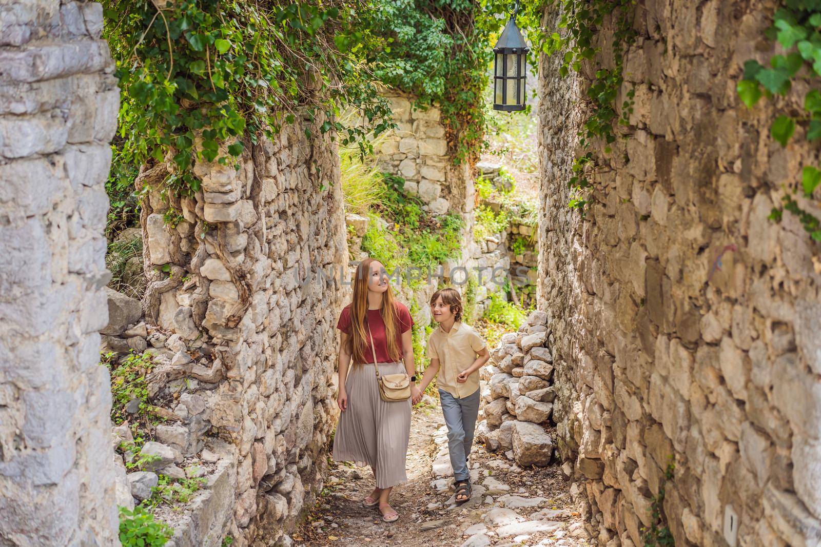 Mom and son tourists walks through the old town of Bar in Montenegro. Happy tourist walks in the mountains. Suburbs of the city of Bar, Montenegro, Balkans. Beautiful nature and landscape.