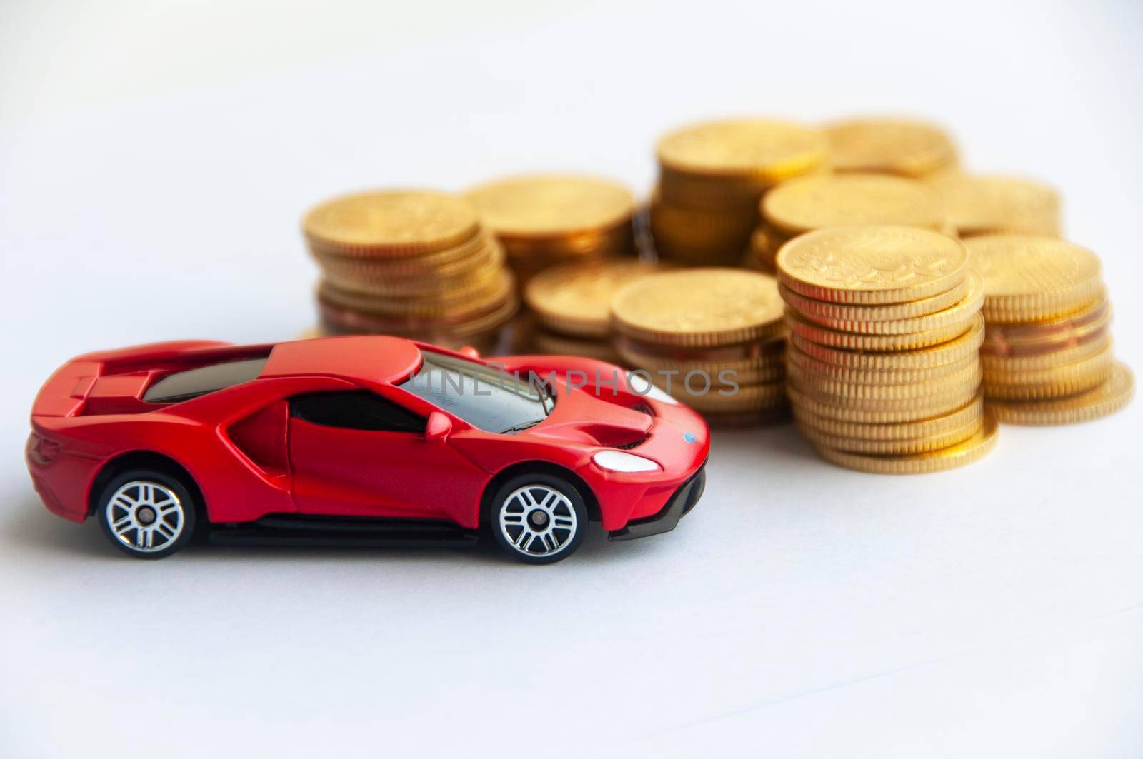 Kuala Lumpur, Malaysia - September 2022 : Miniature toy car of Ford GT with gold coin background. Copy space.