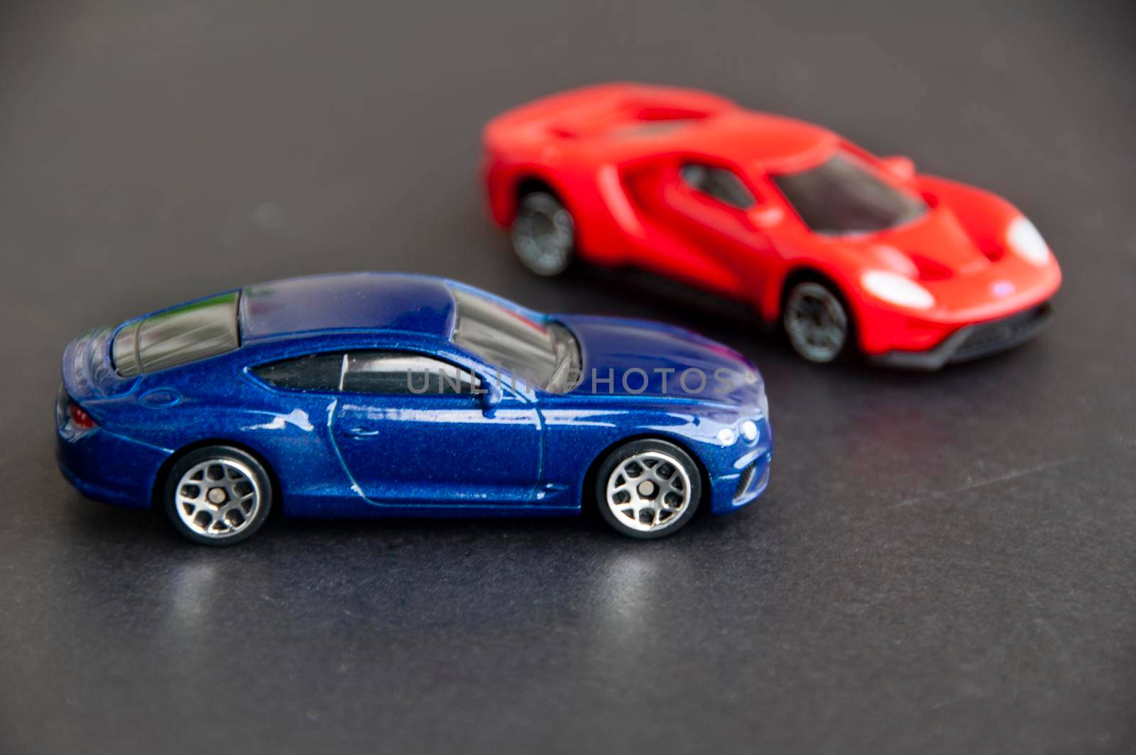 Kuala Lumpur, Malaysia - September 2022 : Miniature toy car of Bentley Continental GT and Ford GT on black cover background. Copy space.