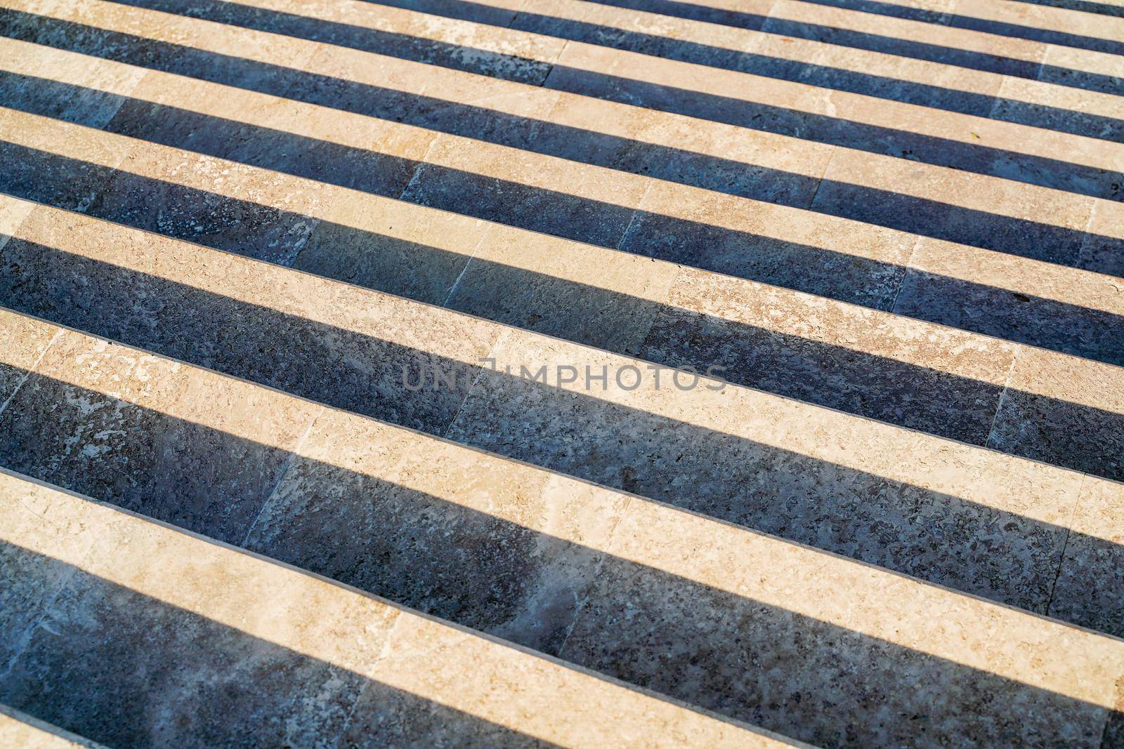 Staircase in the city, black and white pattern on the stairs on a sunny day. by Matiunina