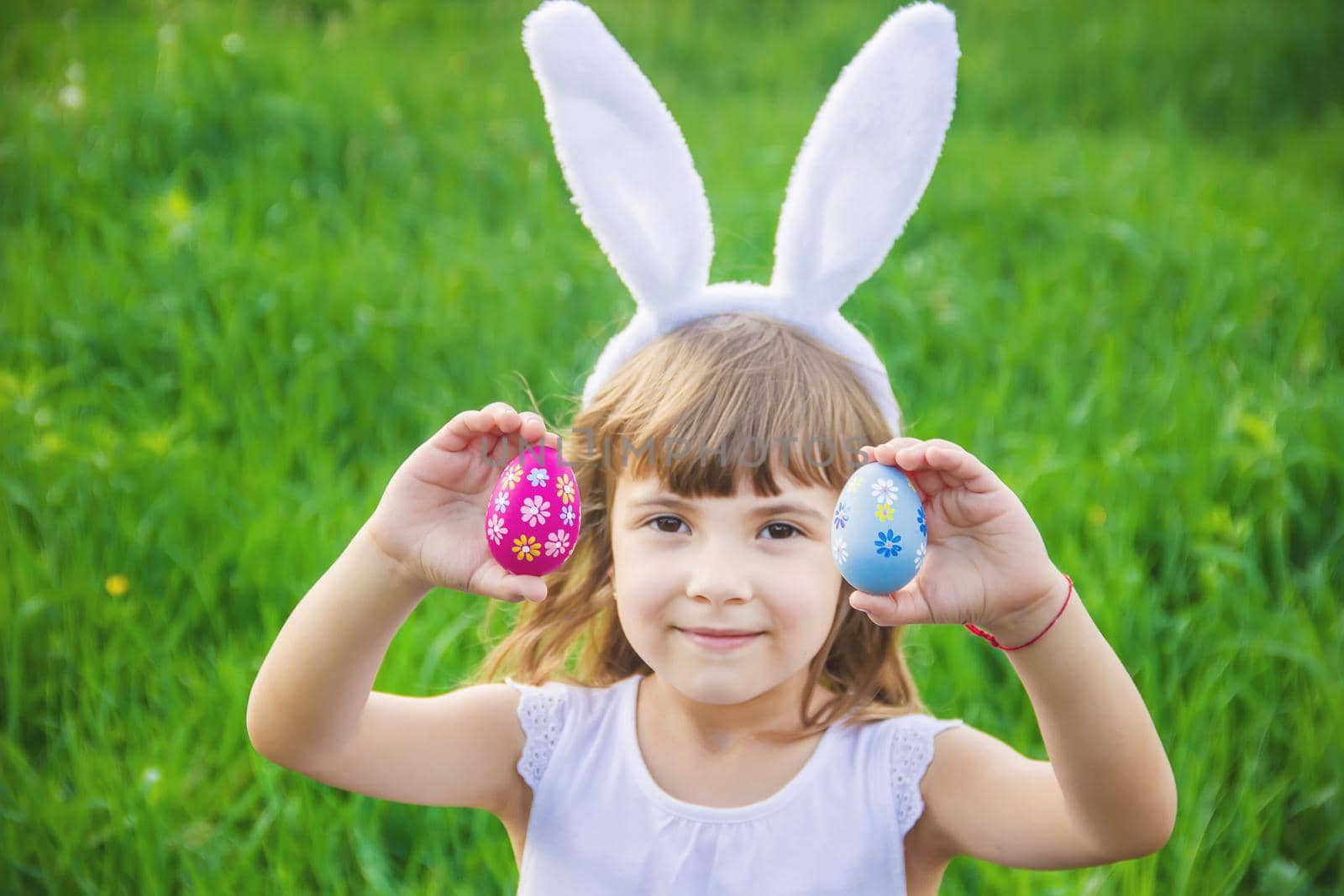 Child with rabbit ears. Easter. Selective focus nature