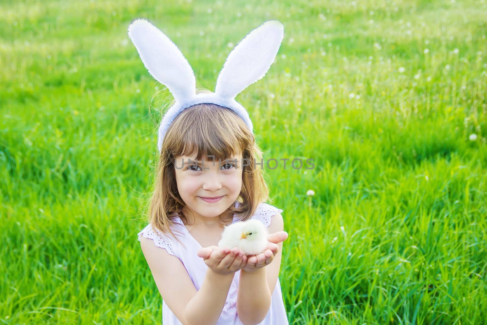 Child with rabbit ears. Easter. Selective focus. by yanadjana