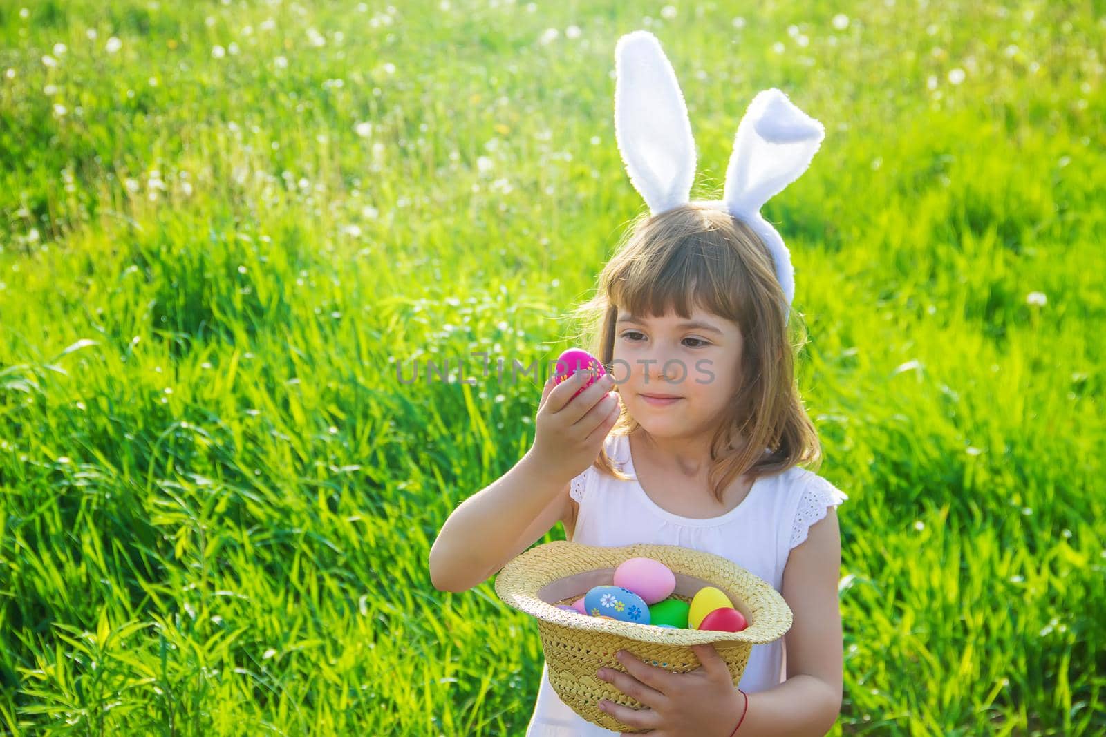 Child with rabbit ears. Easter. Selective focus. by yanadjana