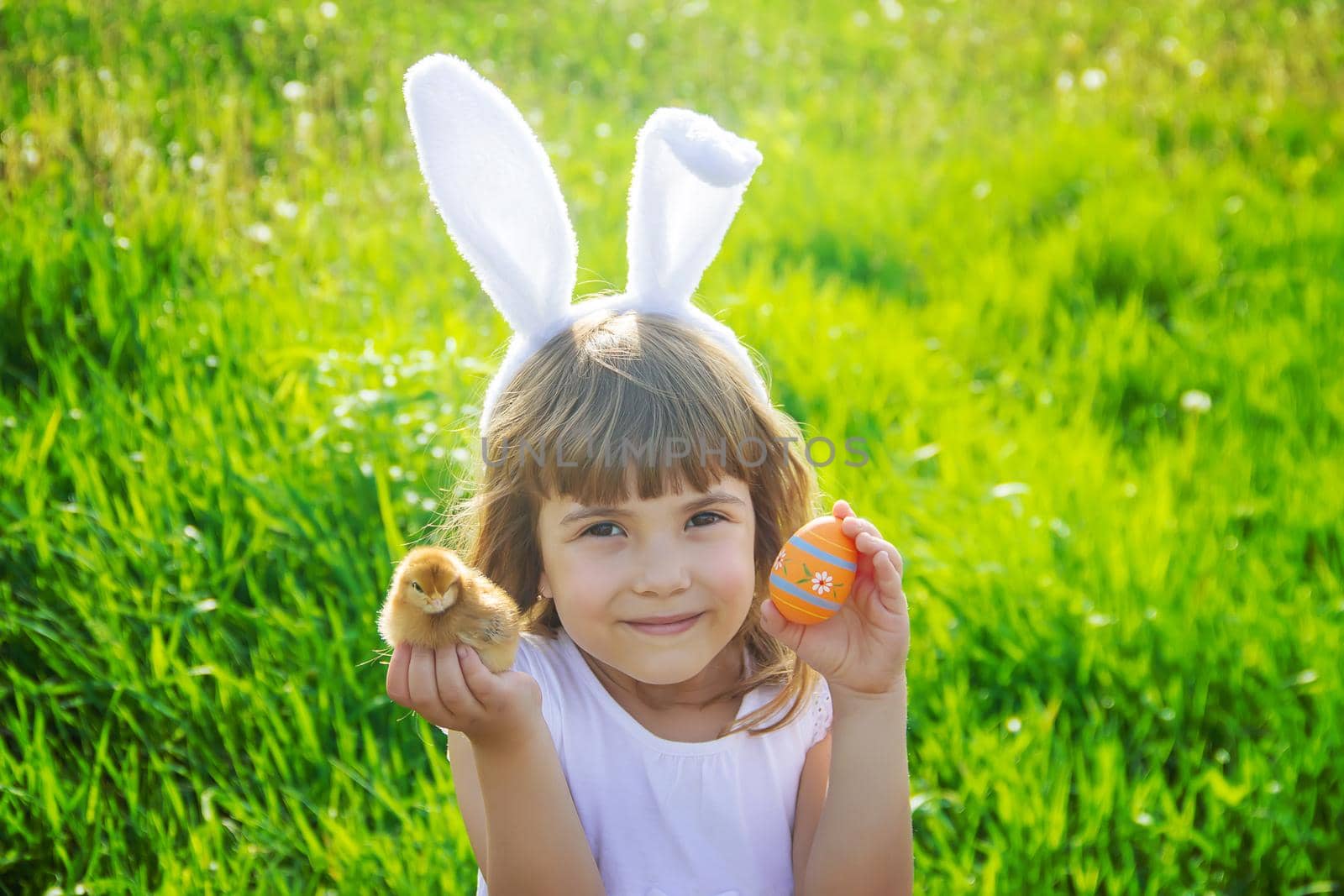 Child with rabbit ears. Easter. Selective focus. by yanadjana