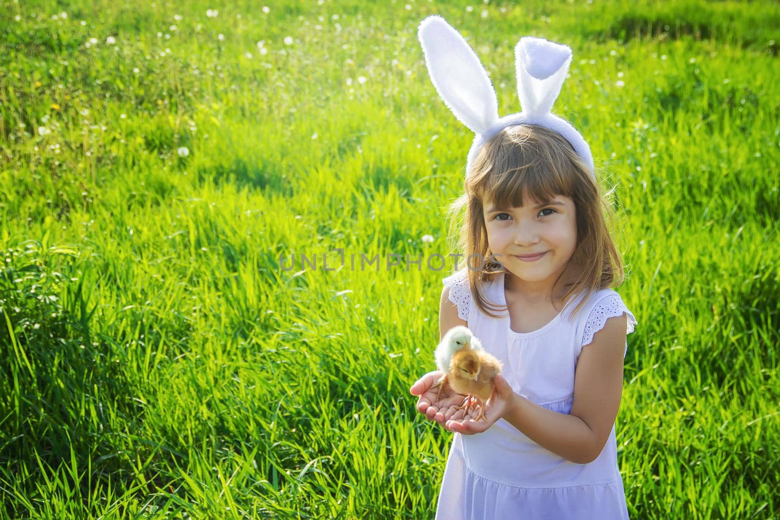 Child with rabbit ears. Easter. Selective focus. by yanadjana