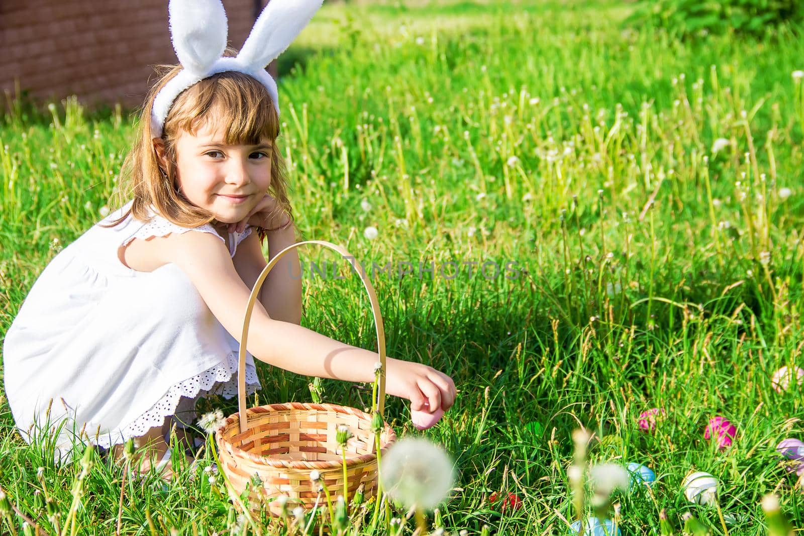 Child with rabbit ears. Easter. Selective focus. by yanadjana