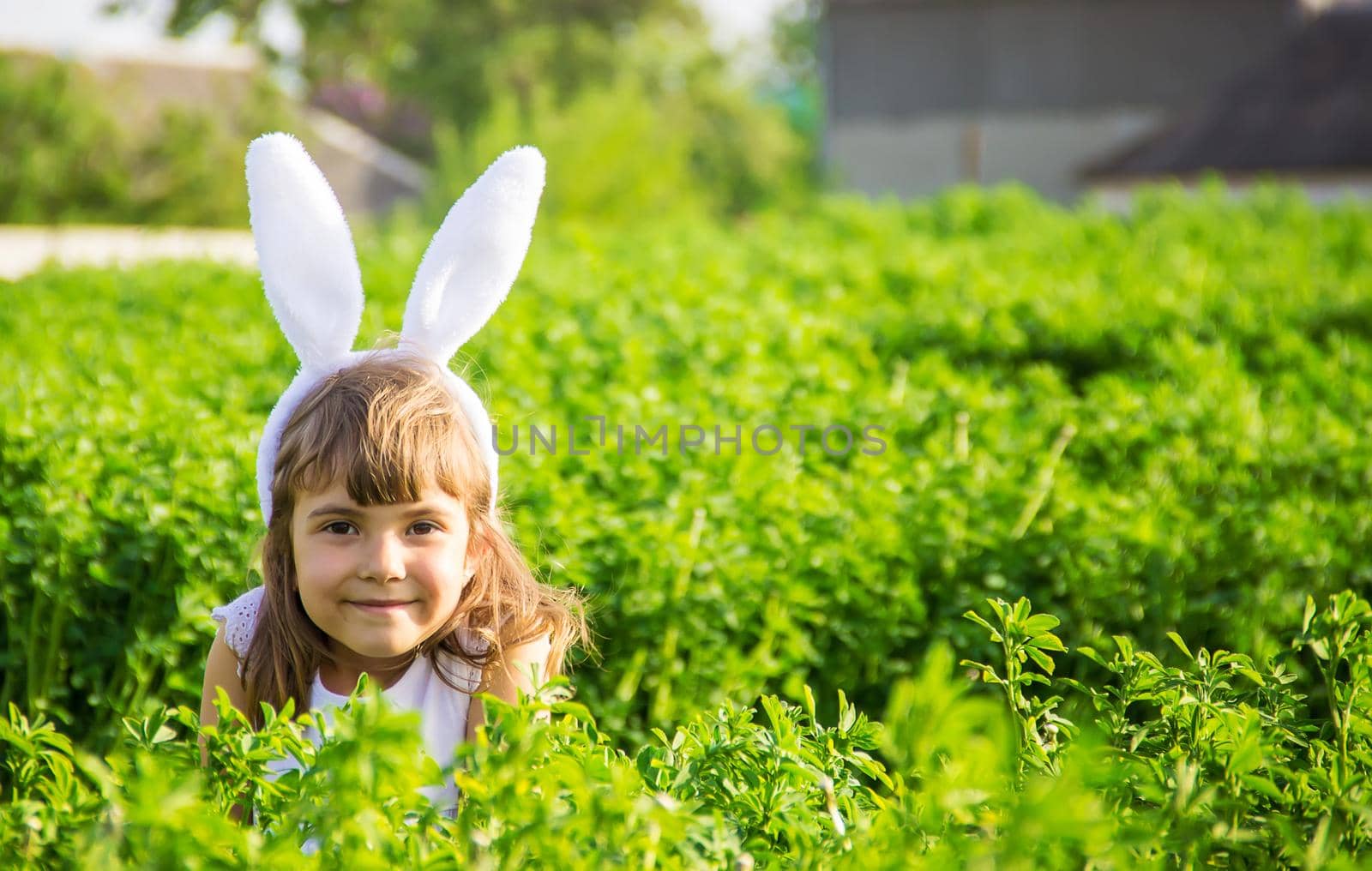 Child with rabbit ears. Easter. Selective focus.