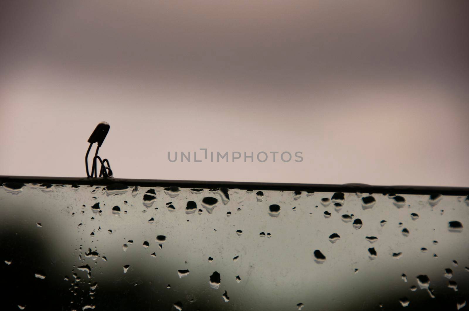 Lonely safety pin sitting on glass wall with customizable space for text and ideas. Lonely concept.