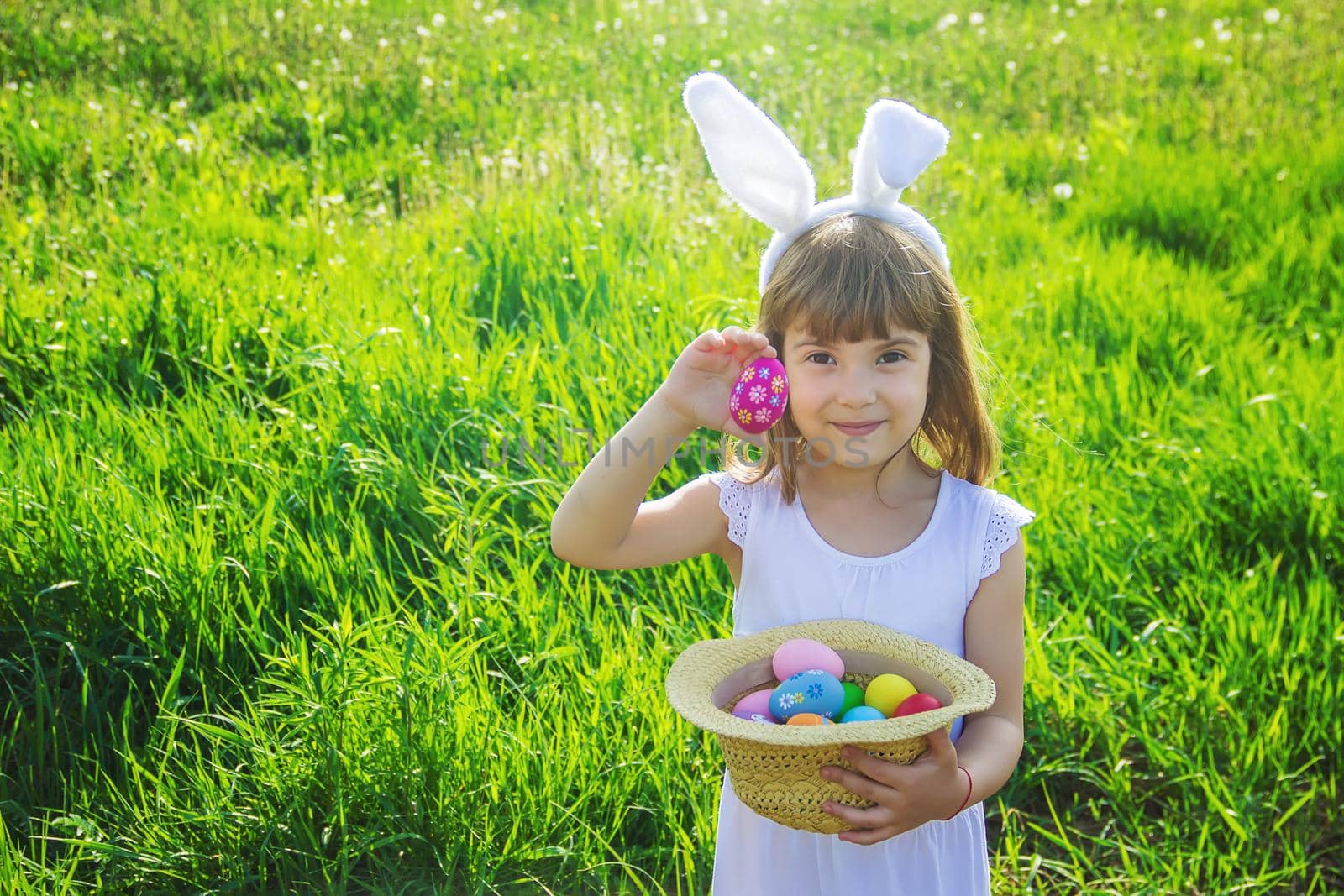 Child with rabbit ears. Easter. Selective focus. by yanadjana