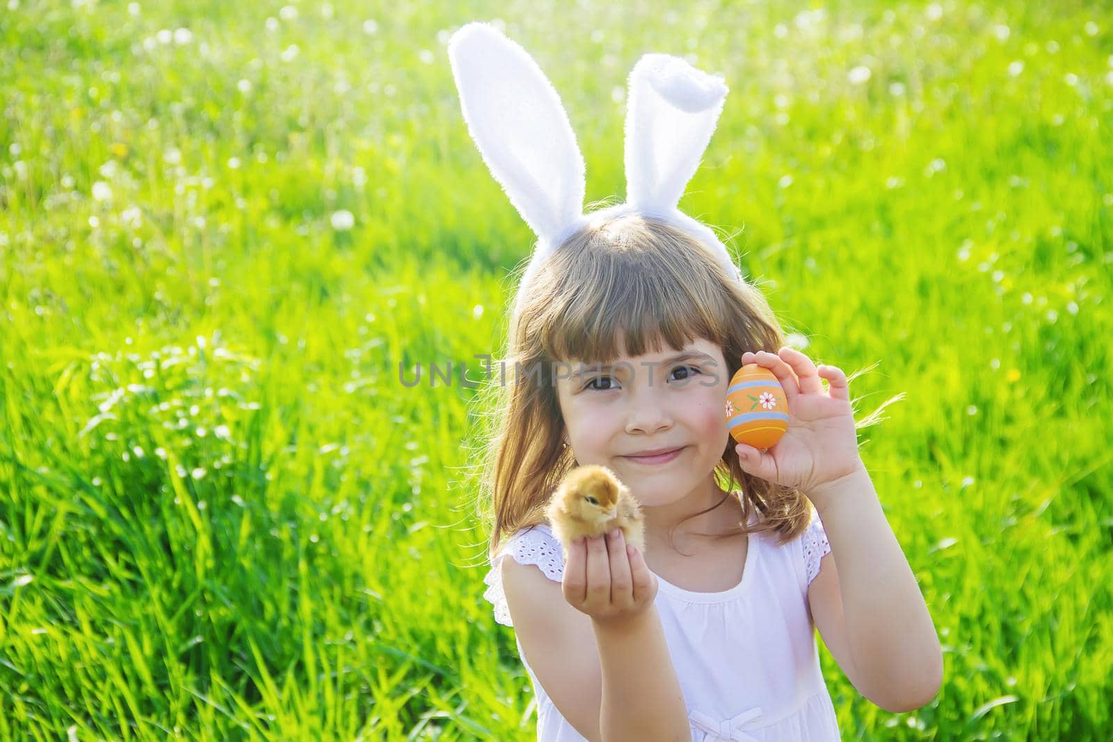 Child with rabbit ears. Easter. Selective focus. by yanadjana