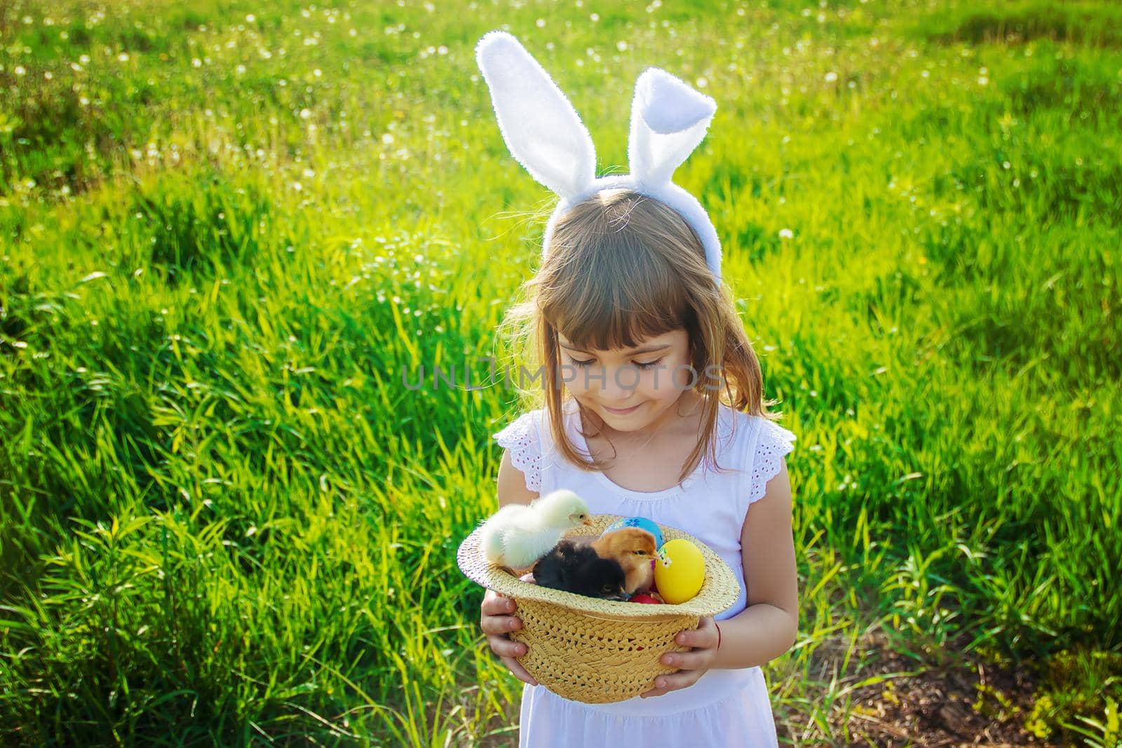 Child with rabbit ears. Easter. Selective focus. by yanadjana