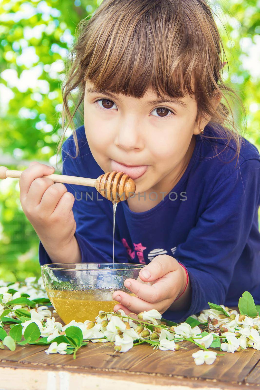 The child eats honey. Selective focus. nature. by yanadjana