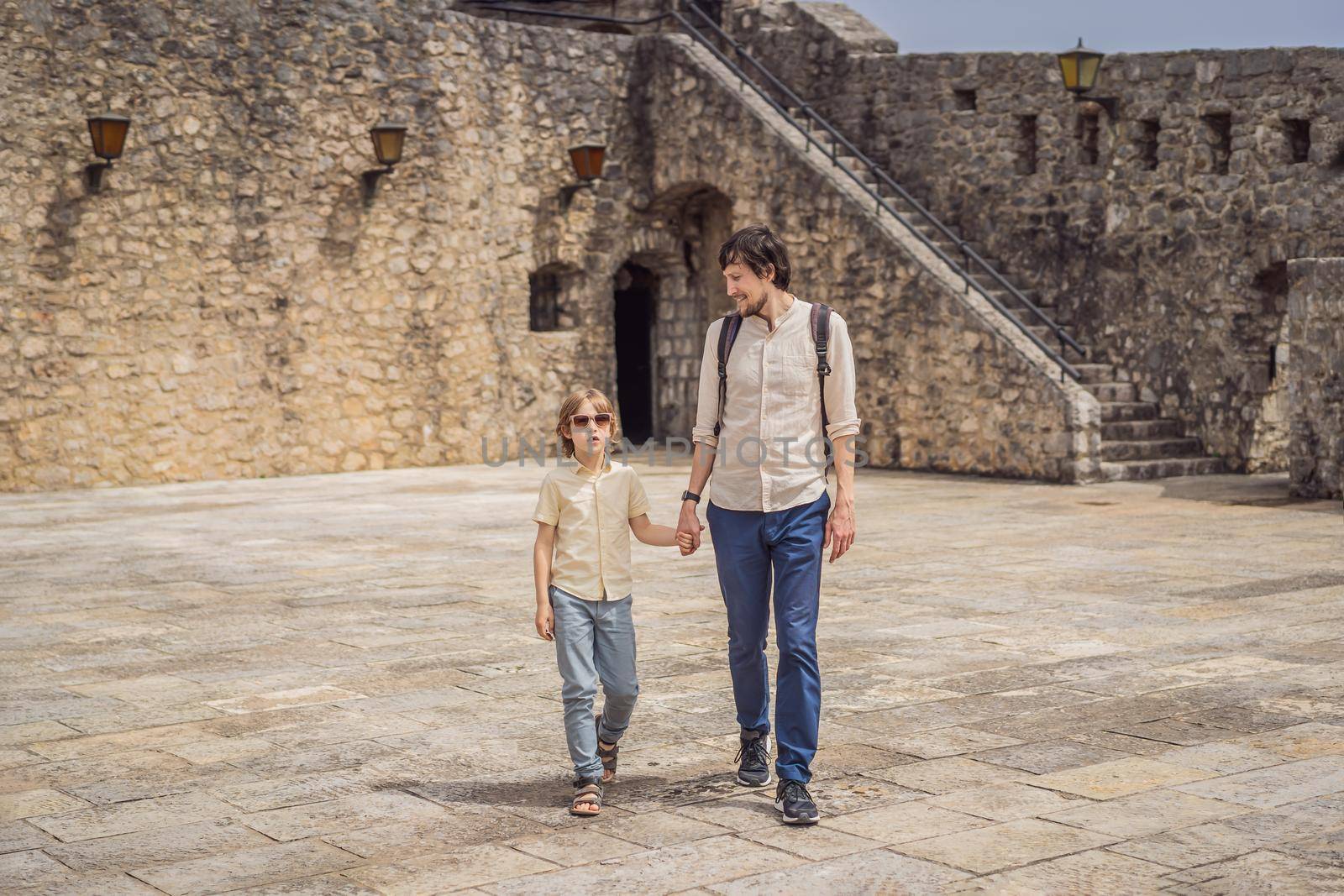 Father and son tourists in Herceg Novi old town. Historical and touristic center of Herceg Novi. Montenegro.