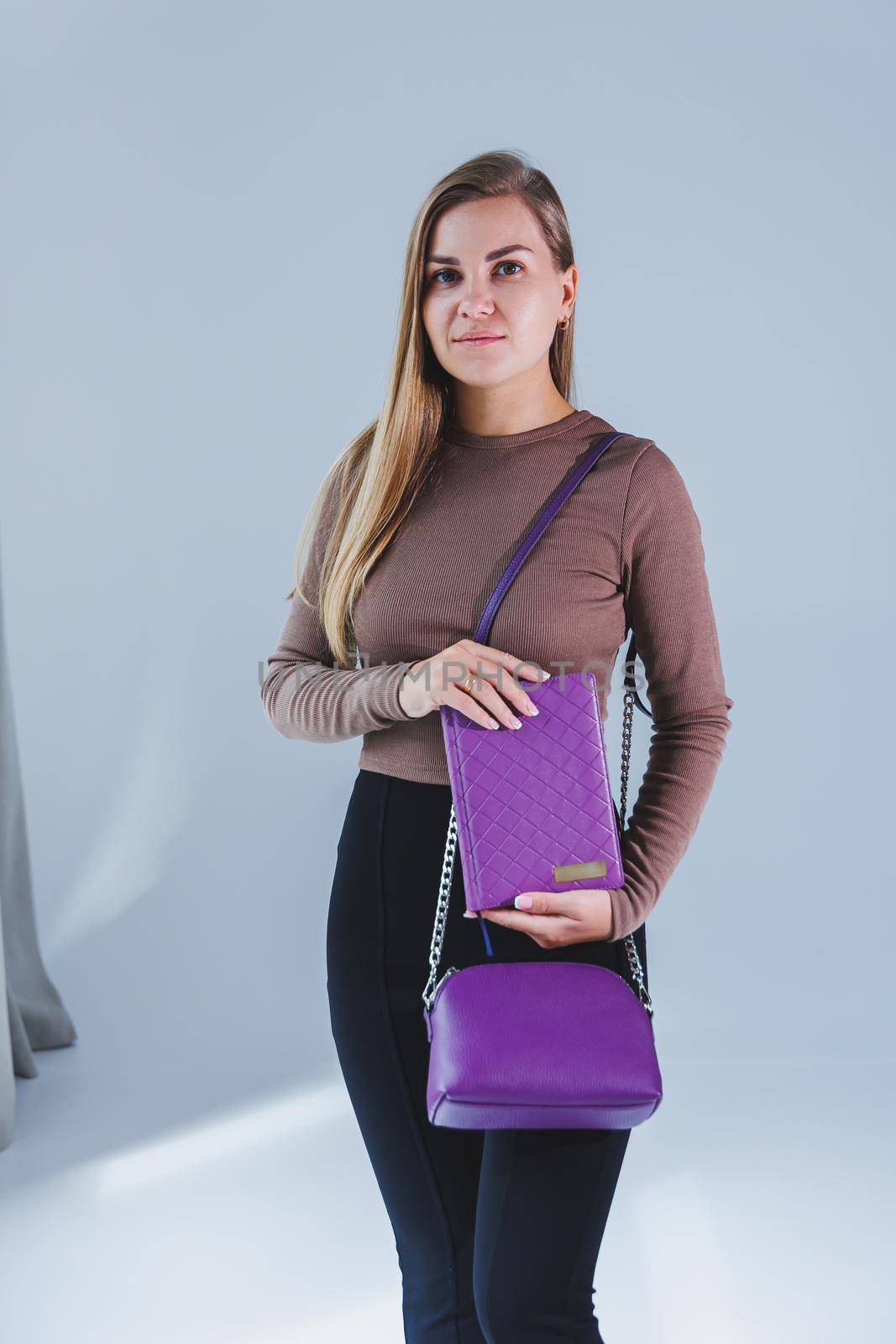 A stylish woman holds a notebook in her hands. Notebook for business records.