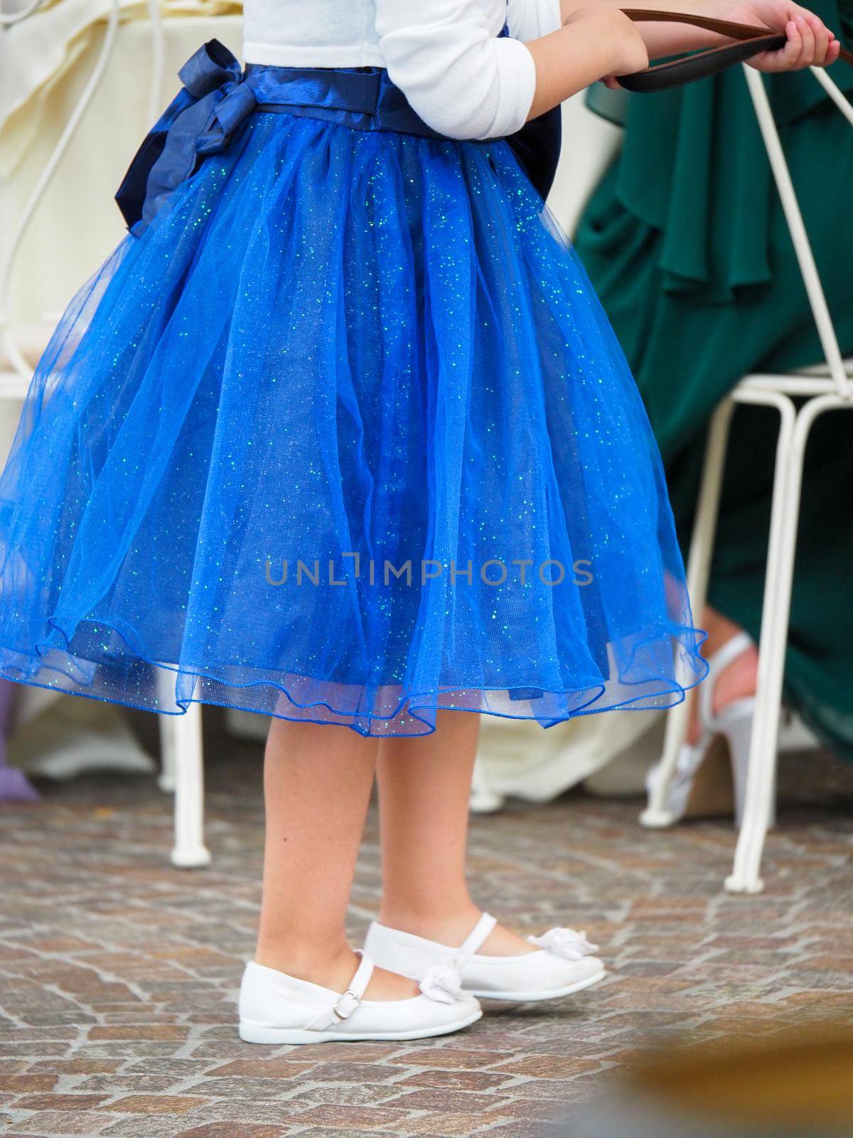 Beautiful baby girl in a blue dress running