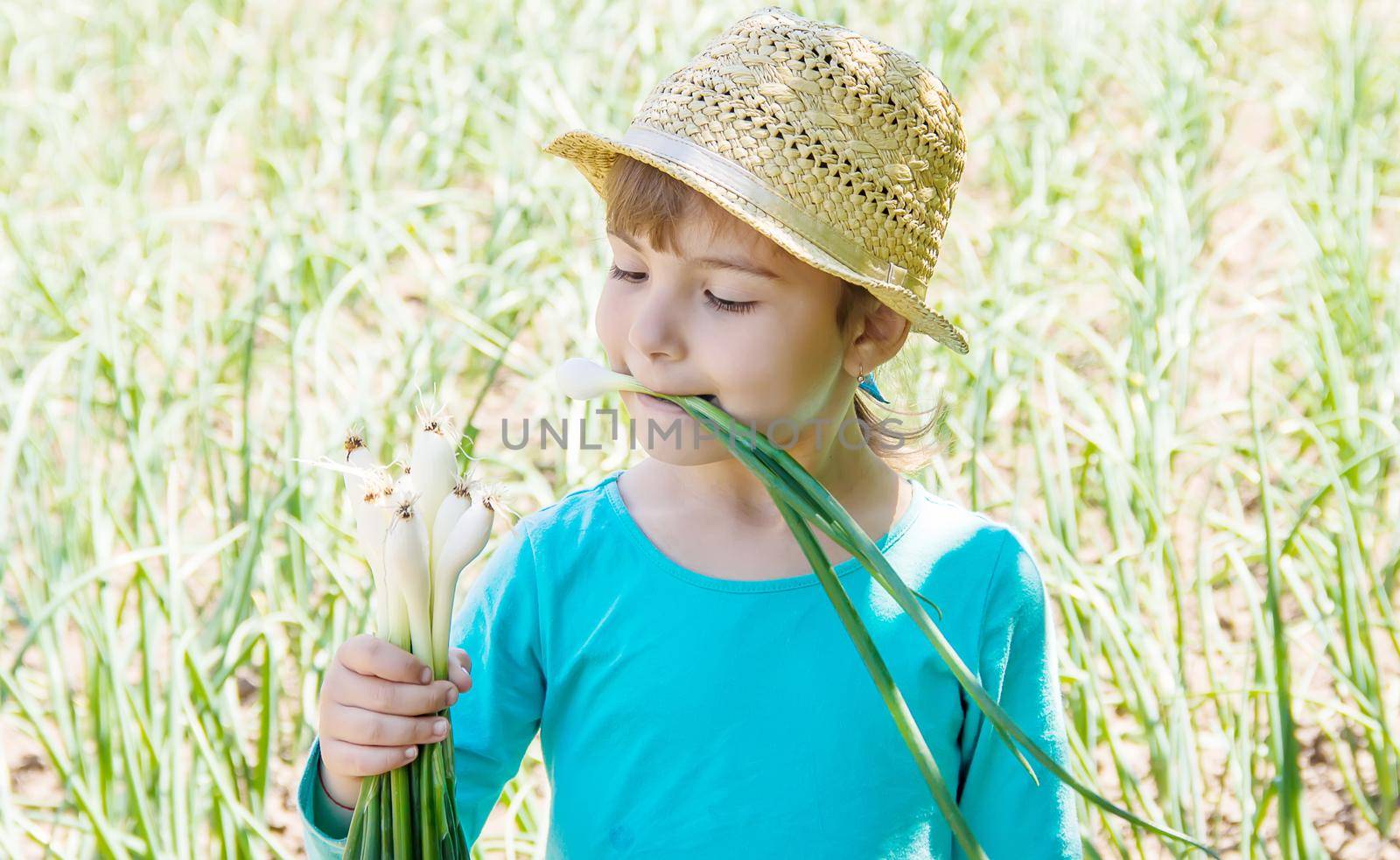 child is holding a young green bow. selective focus. by yanadjana