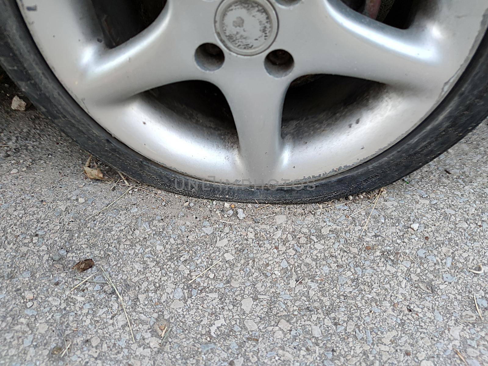 flat punctured car wheel after an accident close up