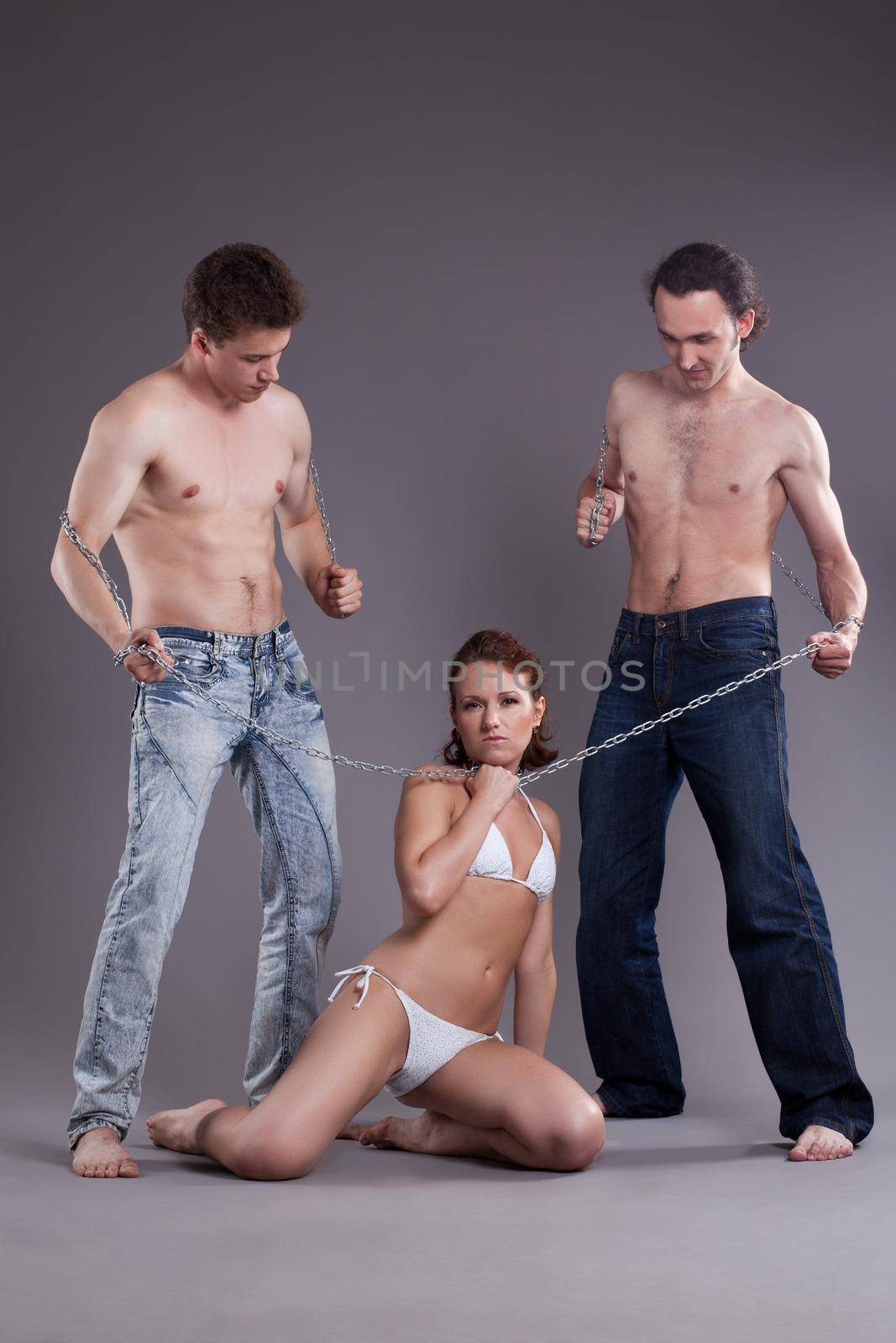 Full length portrait of bisexual men and women with chain