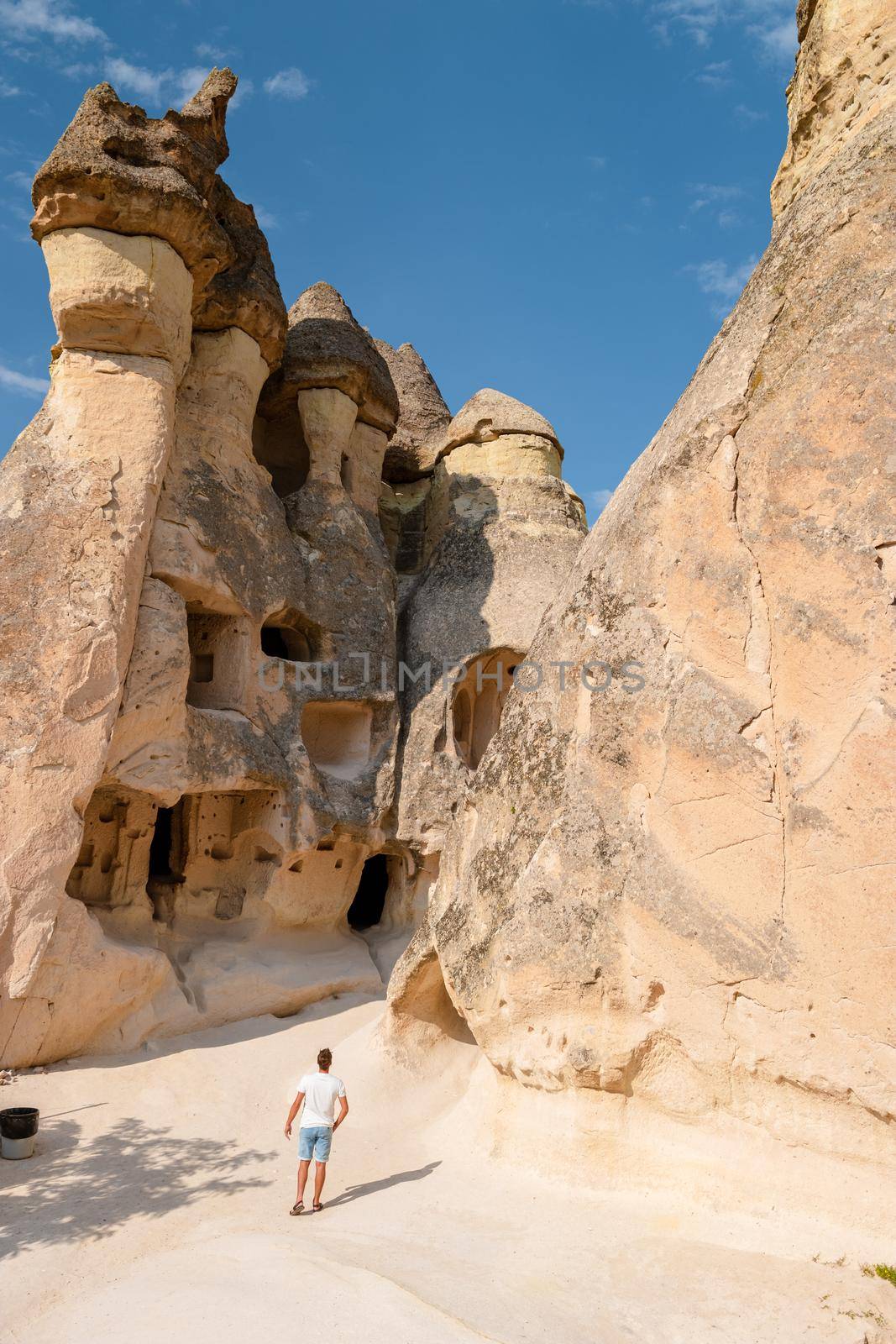 Pasabag Monks Valley happy young menon vacation in Turkey Cappadocia, Rock Formations in Pasabag Monks Valley, Cappadocia, Turkey.