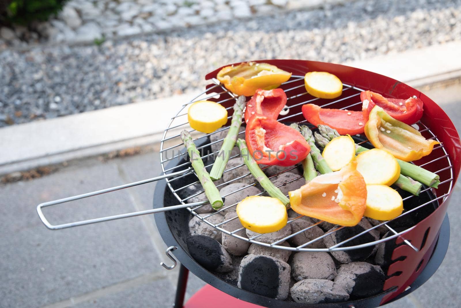 barbecue of colorful raw vegetables on a grill on blue shabby boards, vegetarian food, delicious vegan food, summer picnics. High quality photo