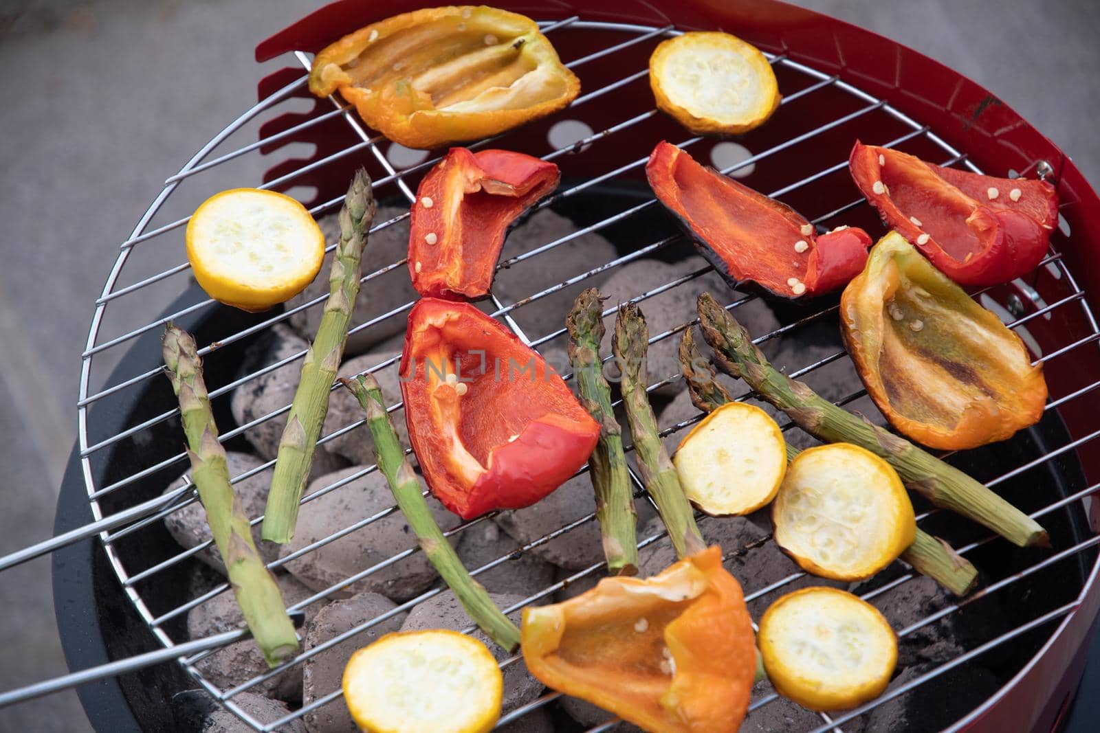 barbecue of colorful raw vegetables on a grill on blue shabby boards, vegetarian food, delicious vegan food, summer picnics. High quality photo